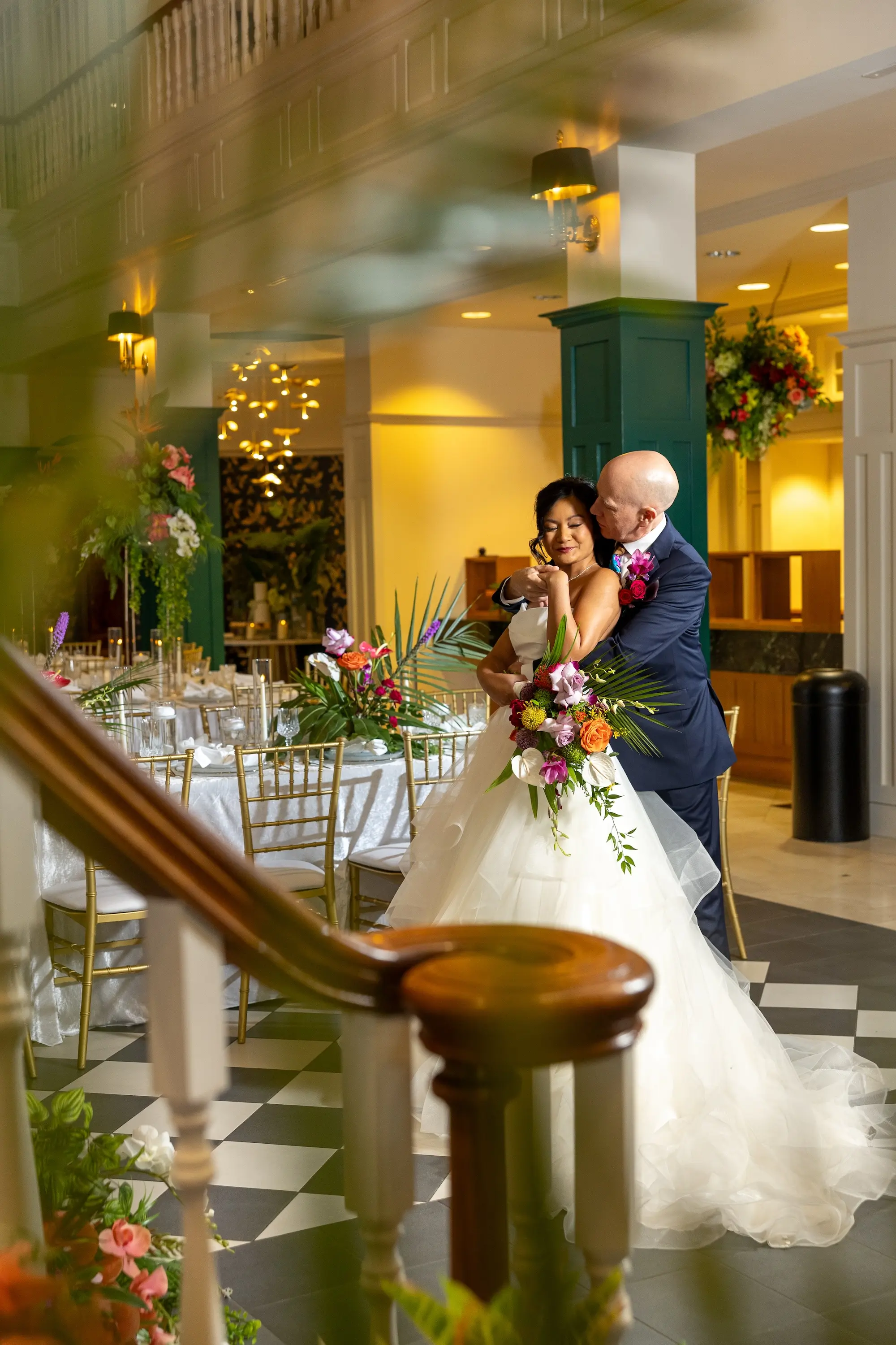 Modern Classic Wedding Inspiration | White Strapless Wedding Ballgown Ideas | Black and White Checkered Reception Floor Inspiration | White Linens with Gold Chiavari Chairs Ideas | Bright Jewel Toned Tropical Floral Centerpieces Decor Inspiration | Tampa Bay Wedding Venue The Spiral Staircase | Sarasota Boutique Truly Forever Bridal