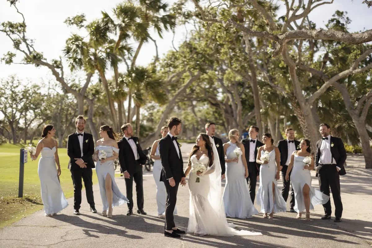 Bride and Groom with Wedding Party Outdoor Wedding Portrait | White Strapless Isabel O'Neil Lace and Tulle Mermaid Wedding Gown with Sweetheart Neckline Hanging from Satin Hanger Ideas | Periwinkle Different Style Bridesmaid Dresses Inspiration