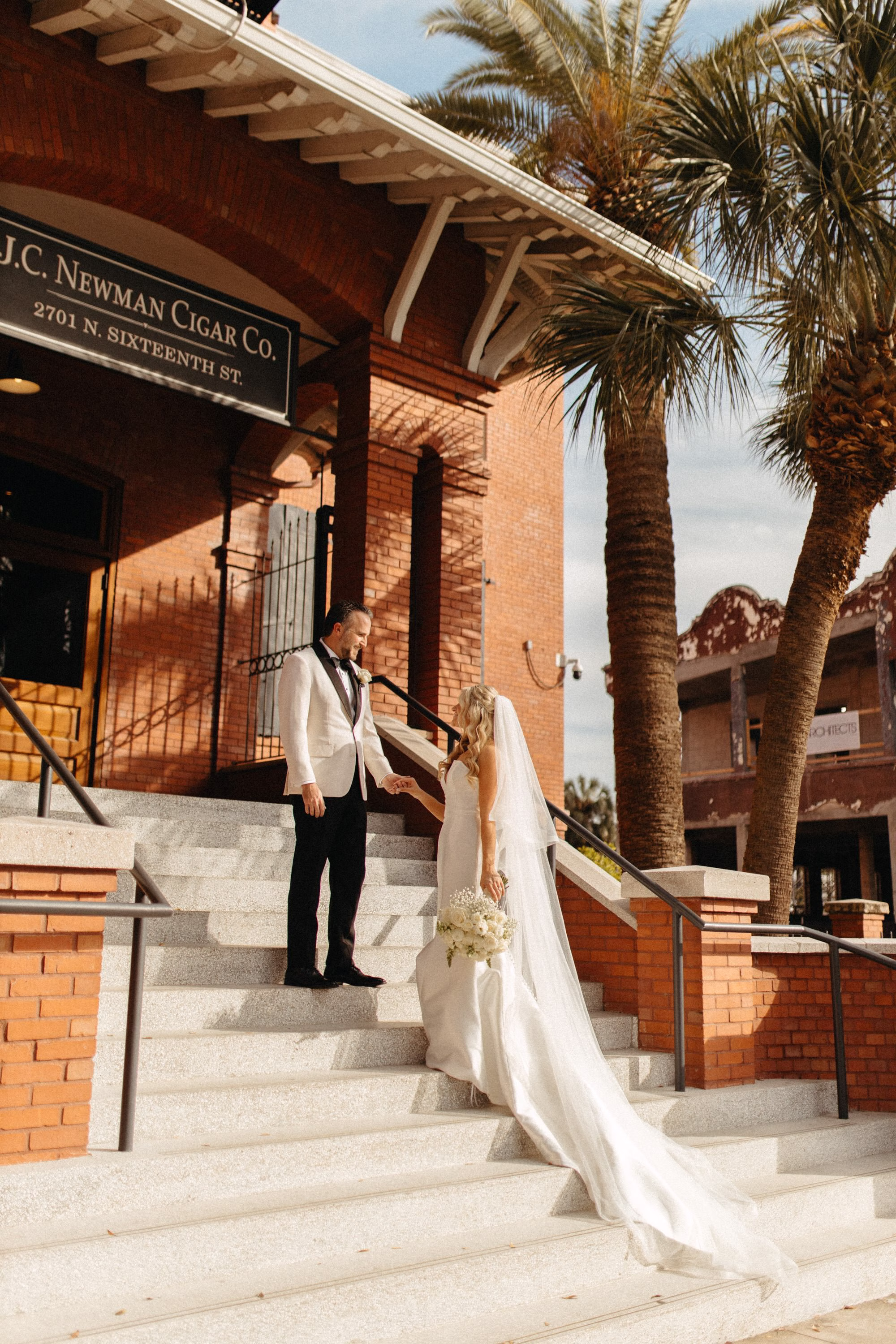Bride and Groom Wedding Portrait | Timeless White White Magnolia Strapless A Line Wedding Gown with Cathedral Tulle Veil Inspiration | Tampa Bay Event Venue JC Newman Cigar Factory