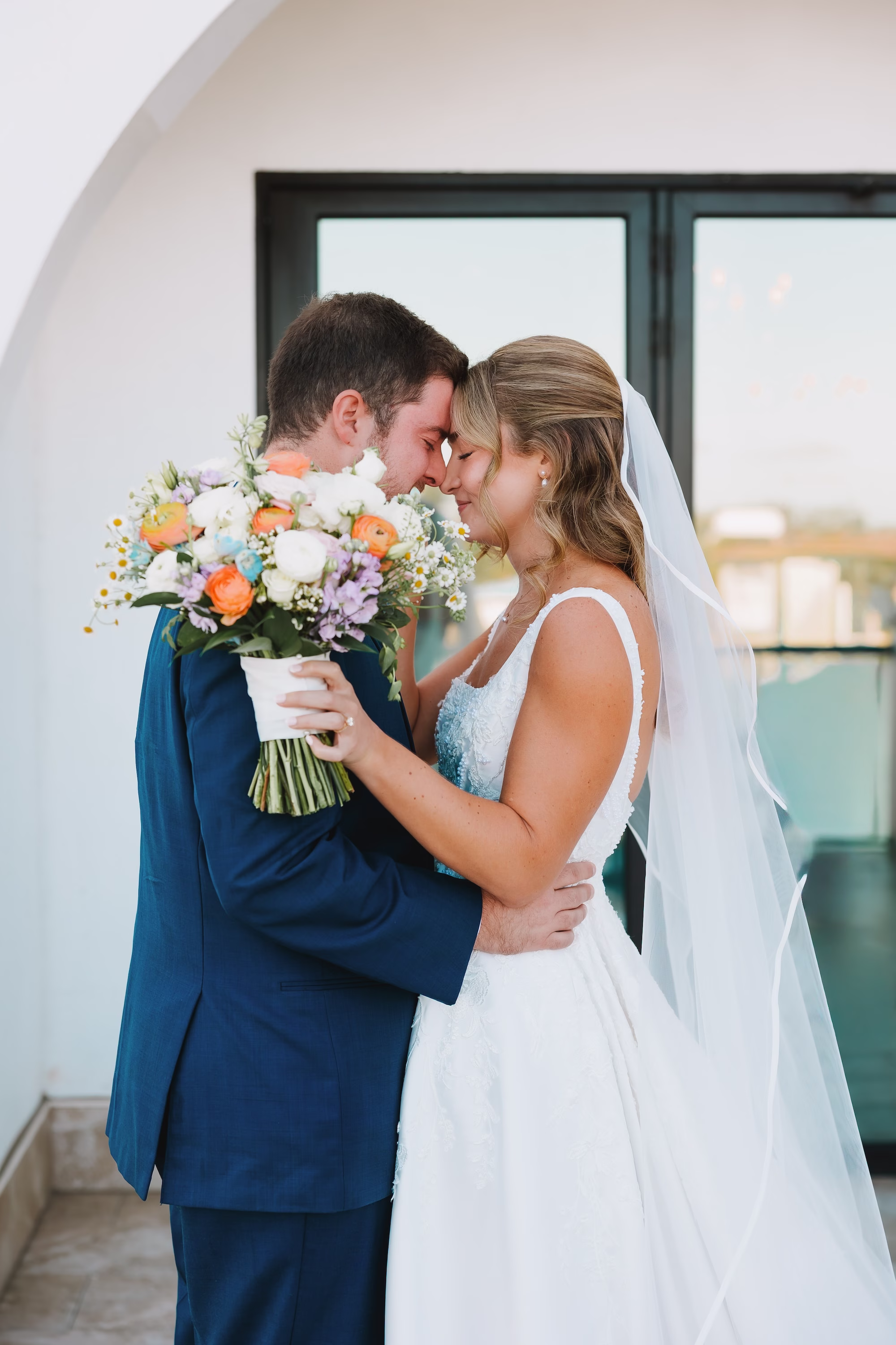 13Coastal Blue and White Rooftop Florida Wedding Ideas - Romantic Blue Coastal St. Pete Beach Wedding | The Hotel Zamora Bride and Groom Wedding Portrait | Classic Half Up Half Down Bridal Hair with Veil Inspiration | Elegant White Magnolia White A-Line Wedding Gown with Square Neckline and Full Skirt Ideas | Soft Pastel Colorful Romantic Bridal Bouquet Coral, Lavender, Yellow, Orange and White Florals of Eucalyptus, Baby's Breath, Roses and Daisies Inspiration | Sarasota Hair and Makeup Artist Femme Akoi Beauty Studio