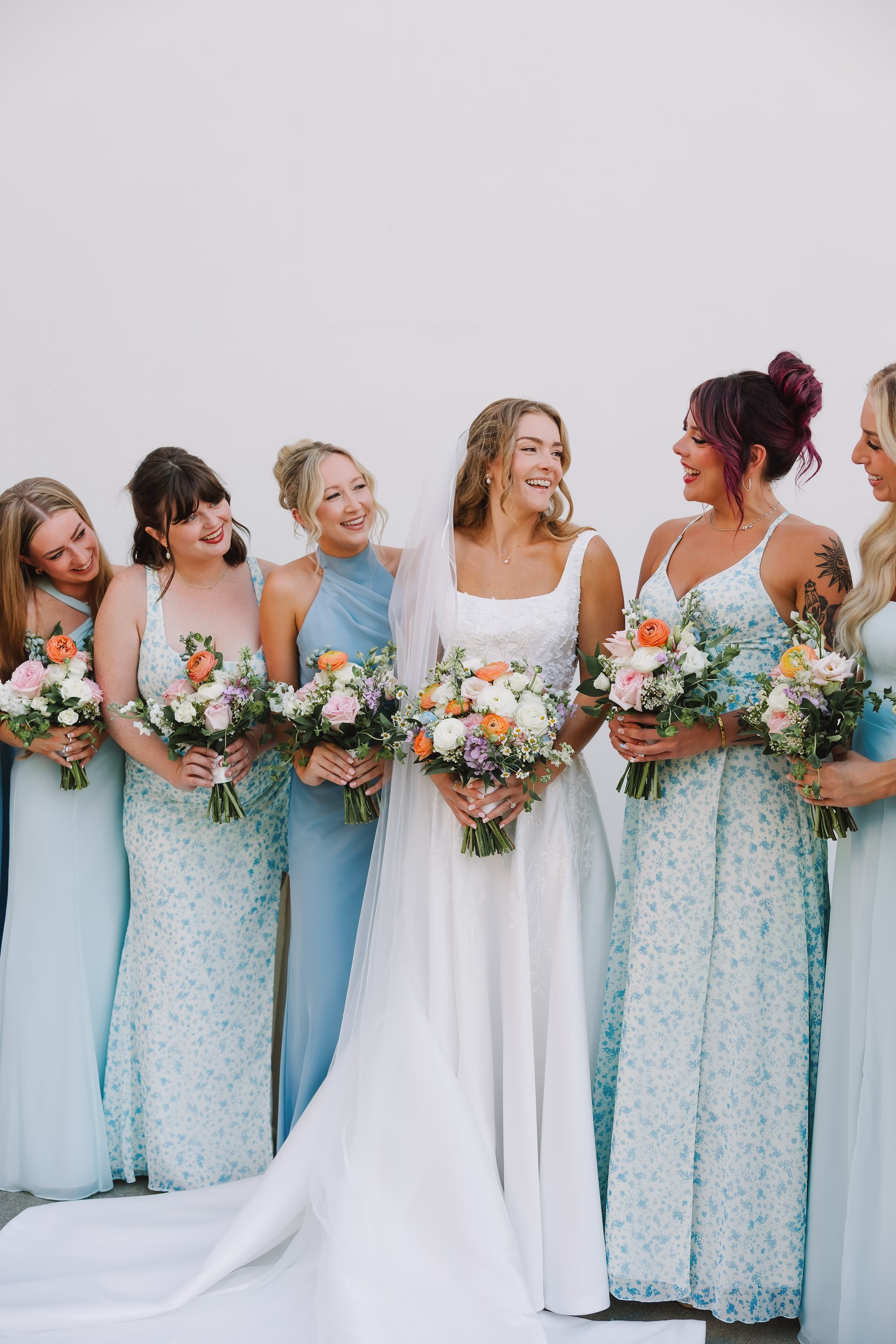 18Coastal Blue and White Rooftop Florida Wedding Ideas - Romantic Blue Coastal St. Pete Beach Wedding | The Hotel Zamora Bride and Bridesmaids Wedding Portrait | Different Style Blue Bridesmaid Dresses Ideas | Elegant White Magnolia White A-Line Wedding Gown with Square Neckline and Full Skirt Inspiration | Colorful Romantic Bouquet Ideas | Classic Traditional Chiffon Veil Inspiration | Timeless Half Up Half Down Bridal Hair with Veil Ideas | Sarasota Hair and Makeup Artist Femme Akoi Beauty Studio