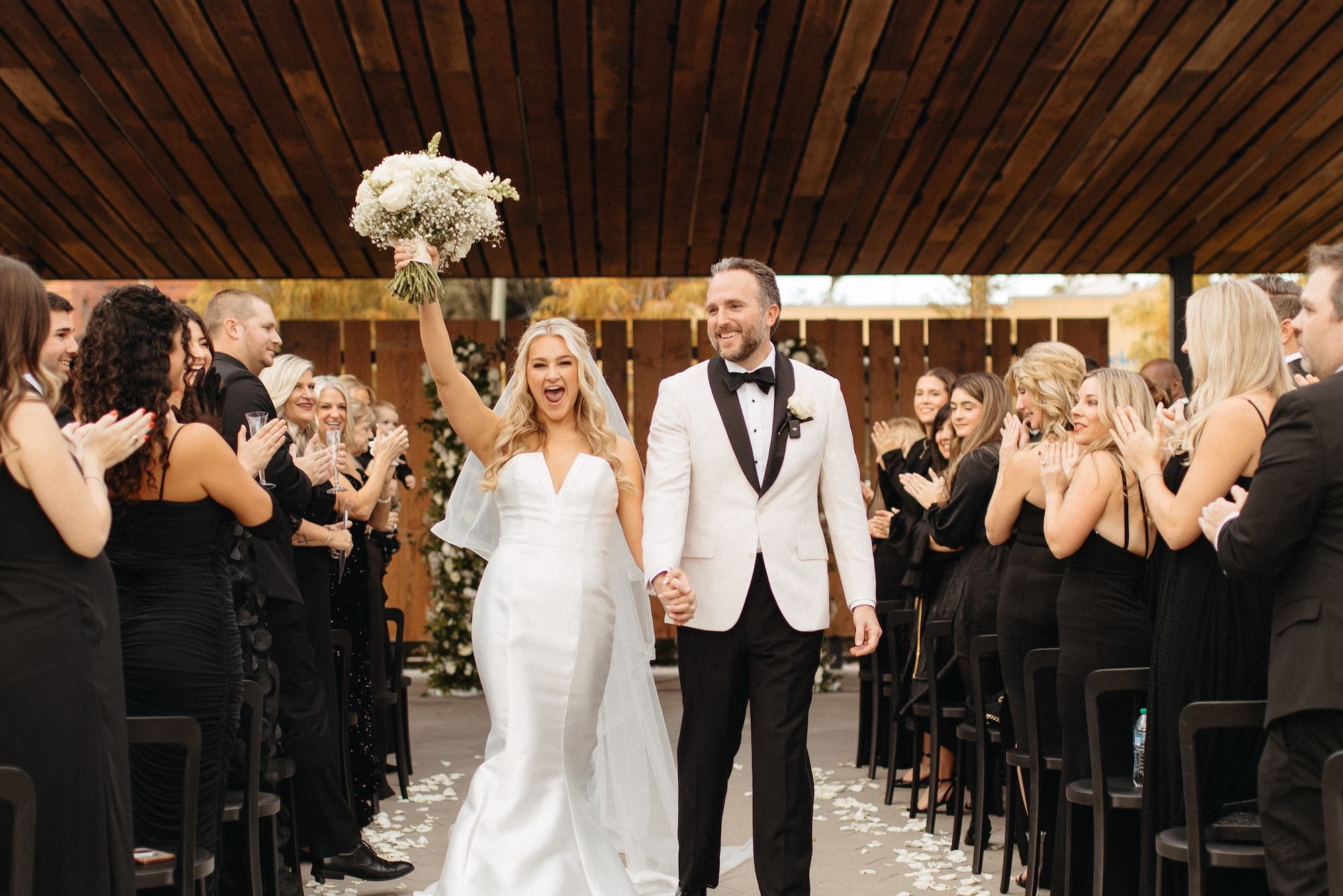 Bride and Groom Just Married Wedding Ceremony Portrait | Classic White Roses and White Baby's Breath with Satin Ribbon Bridal Bouquet Inspiration | White Rose Petals Wedding Ceremony Aisle Decor Ideas | Clearwater Florist Lemon Drops Wedding and Events