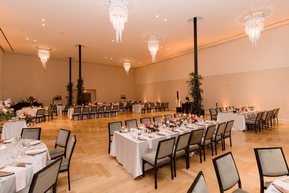 Elegant Chandelier Wedding Reception Ballroom | Romantic Centerpieces with Bright Pink, Blush and Light Pink Roses and Florals in Lush Greenery Flower Arrangement Ideas | Gold Chargers with Light Pink Napkins Wedding Reception Tablescape Decor Inspiration | Florida Event Venue Hotel Haya