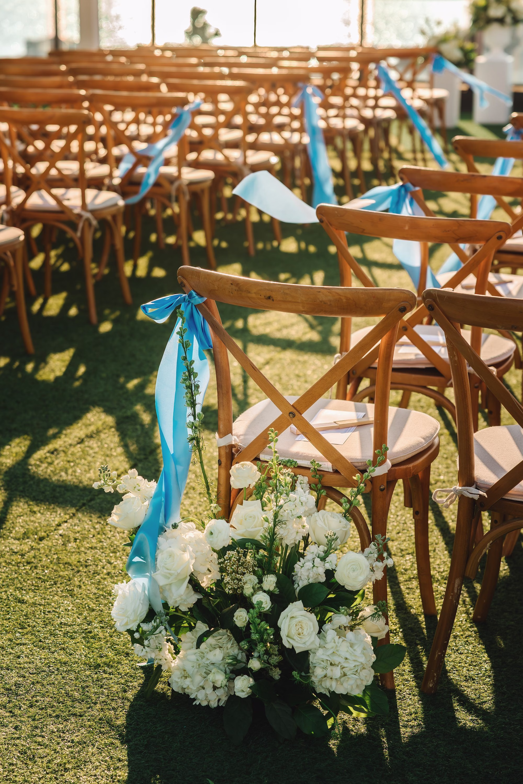 21Coastal Blue and White Rooftop Florida Wedding Ideas - Romantic Blue Coastal St. Pete Beach Wedding | The Hotel Zamora Waterfront Rooftop Wedding Ceremony Inspiration | Timeless Rustic Wooden Cross-Back Ceremony Chairs with Coastal Blue Ribbon Decor Ideas | Monochromatic White Flower Arrangement with Roses and Hydrangeas Inspiration | St Petersburg Wedding Planner Seashine Weddings