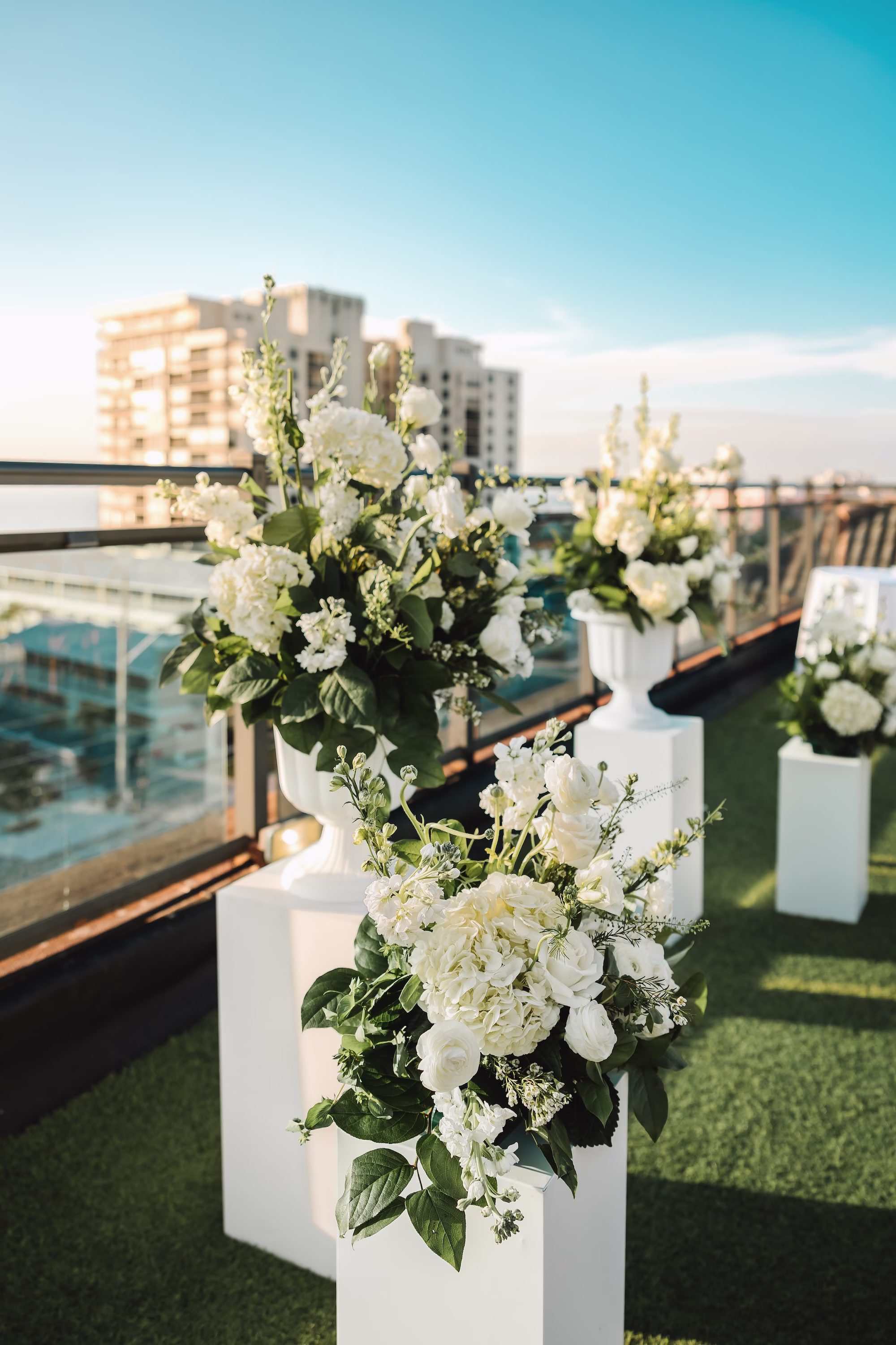 25Coastal Blue and White Rooftop Florida Wedding Ideas - Romantic Blue Coastal St. Pete Beach Wedding | The Hotel Zamora Waterfront Rooftop Wedding Ceremony Inspiration | Monochromatic White Flower Arrangement Altar Decor with Roses and Hydrangeas Inspiration | St Petersburg Wedding Planner Seashine Weddings | Beach Wedding Venue Hotel Zamora