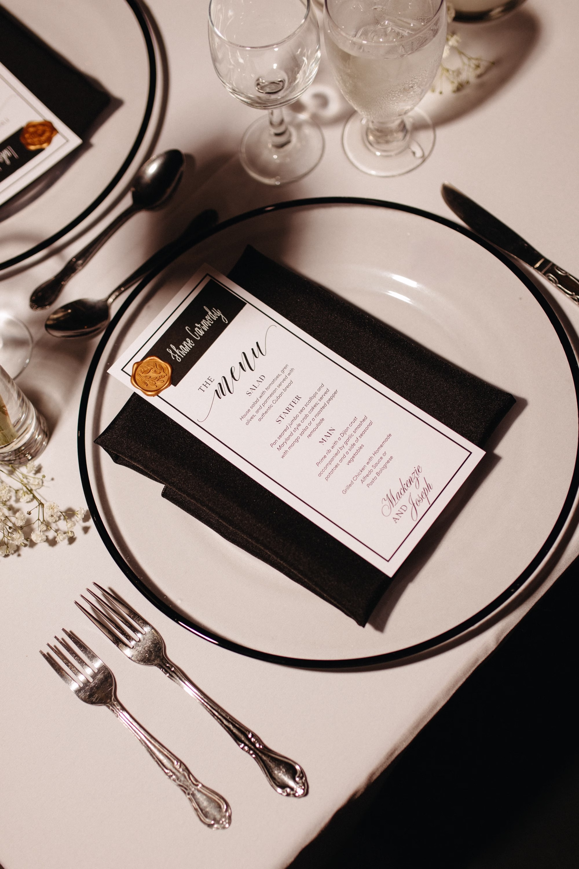 Romantic Black and White Tablescape Wedding Reception Decor Inspiration | Clear Charger with Silver Rim and Black Napkin with White Menu Card Decor Ideas | Sarasota Planner B Eventful | Tables and Linens Rentals A Chair Affair