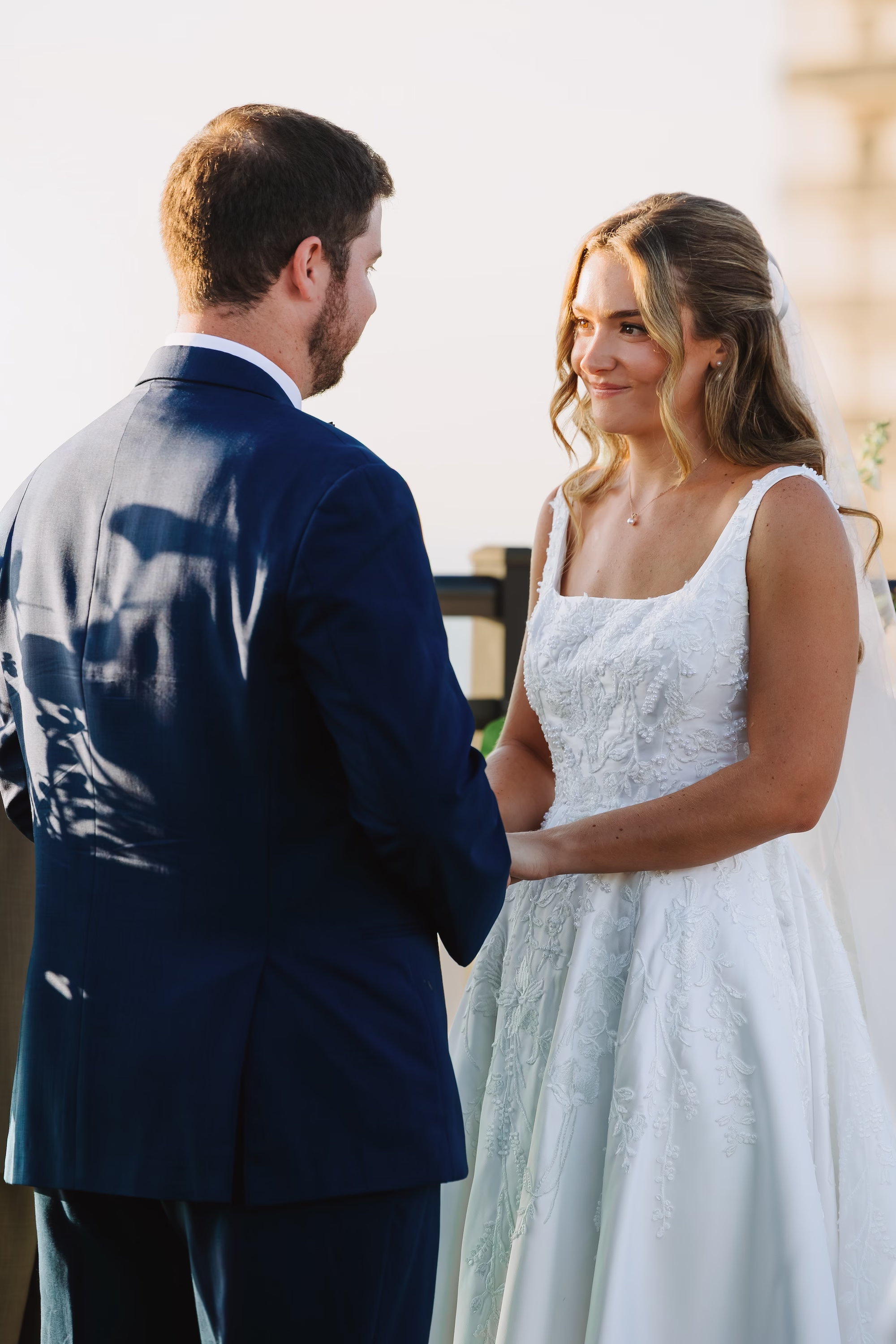 29Coastal Blue and White Rooftop Florida Wedding Ideas - Romantic Blue Coastal St. Pete Beach Wedding | The Hotel Zamora Bride and Groom Wedding Ceremony Vow Exchange Wedding Portrait | Waterfront Rooftop Wedding Ceremony Inspiration | Classic Half Up Half Down Soft Curled Bridal Hair with Veil Inspiration | Elegant White Magnolia White A-Line Wedding Gown with Square Neckline and Full Skirt Ideas | Sarasota Hair and Makeup Artist Femme Akoi Beauty Studio