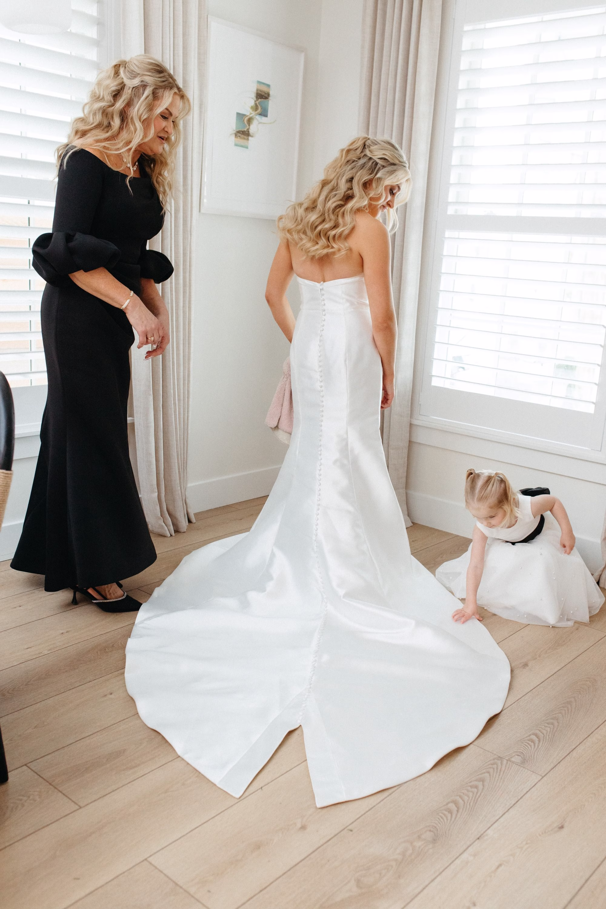 Bride and Mother Getting Ready Wedding Portrait | White Magnolia Strapless Wedding Dress with Long Train and Button Back Detailing Inspiration