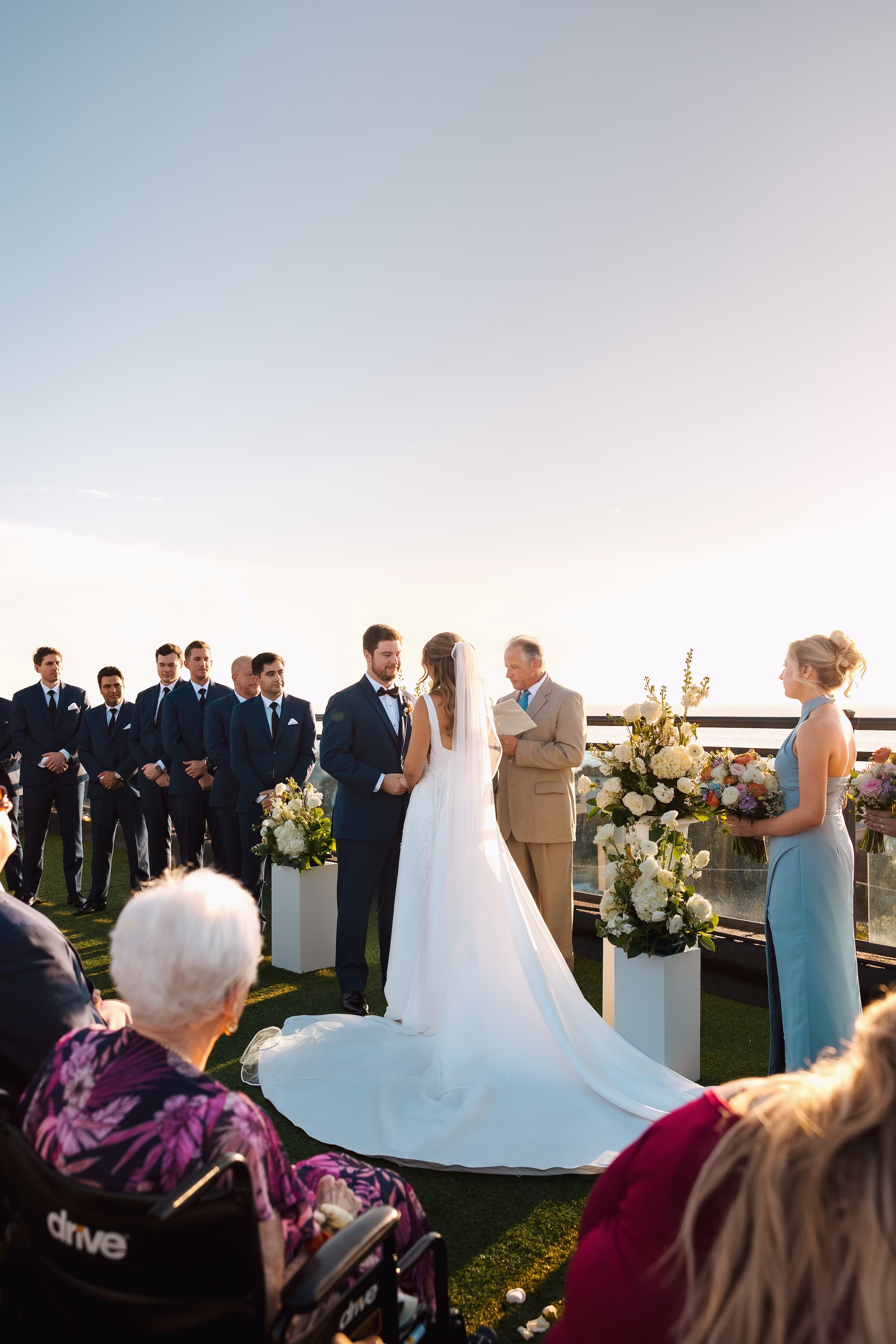 30Coastal Blue and White Rooftop Florida Wedding Ideas St Pete Venue Hotel Zamora - Romantic Blue Coastal St. Pete Beach Wedding | The Hotel Zamora Bride and Groom Wedding Ceremony Vow Exchange Wedding Portrait | Waterfront Rooftop Wedding Ceremony Inspiration | Monochromatic White Flower Arrangement Altar Decor with Roses and Hydrangeas Inspiration | Classic Half Up Half Down Soft Curled Bridal Hair Ideas | St Petersburg Wedding Planner Seashine Weddings | Sarasota Hair and Makeup Artist Femme Akoi Beauty Studio | St Pete Beach Wedding Venue Hotel Zamora