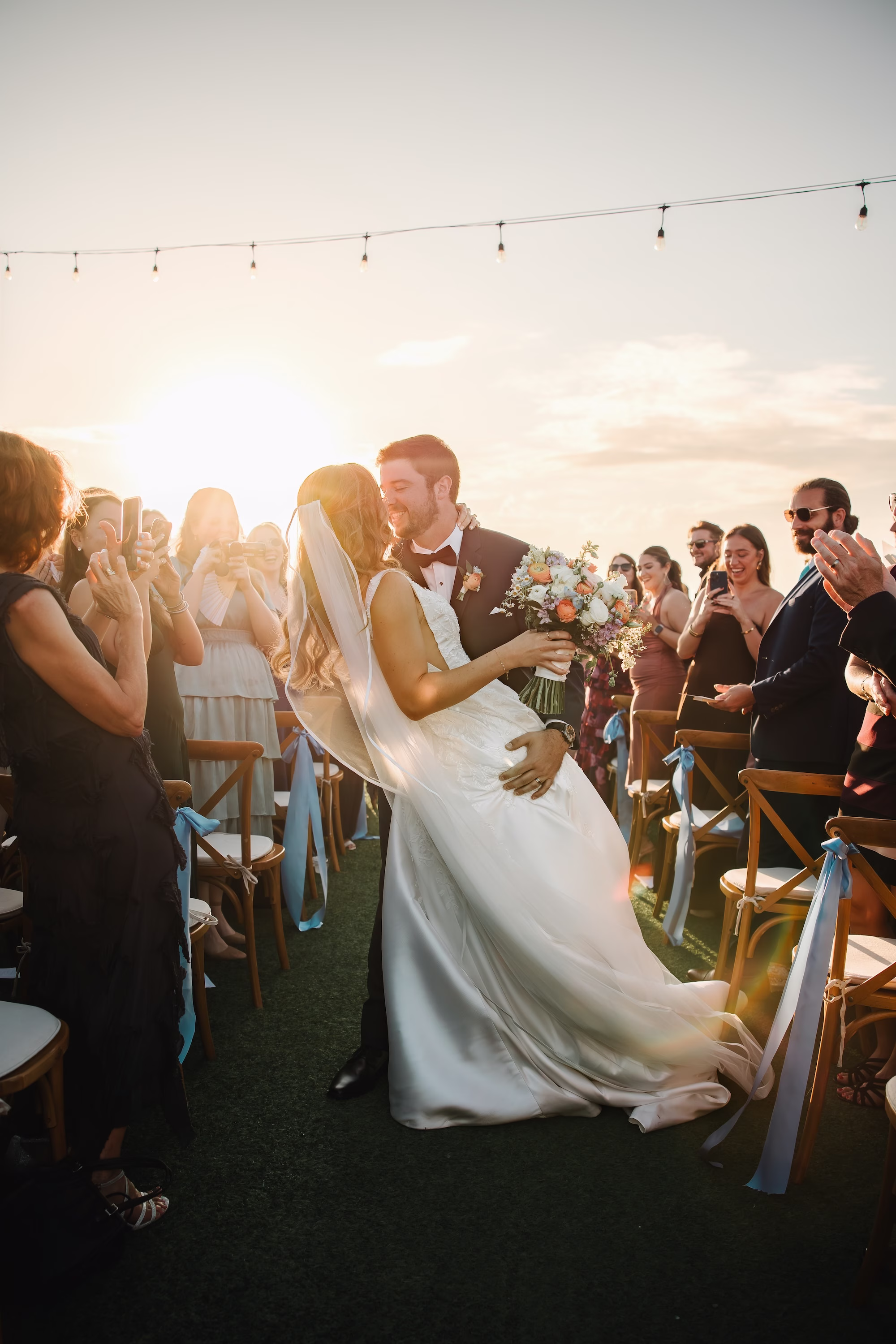 34Coastal Blue and White Rooftop Florida Wedding Ideas St Pete Venue Hotel Zamora - Romantic Blue Coastal St. Pete Beach Wedding | The Hotel Zamora Bride and Groom Wedding Ceremony Just Married Sunset Wedding Portrait | Golden Hour Waterfront Rooftop Wedding Ceremony Inspiration | Classic Half Up Half Down Bridal Hair with Veil Inspiration | Sarasota Hair and Makeup Artist Femme Akoi Beauty Studio | Beach Wedding Venue Hotel Zamora