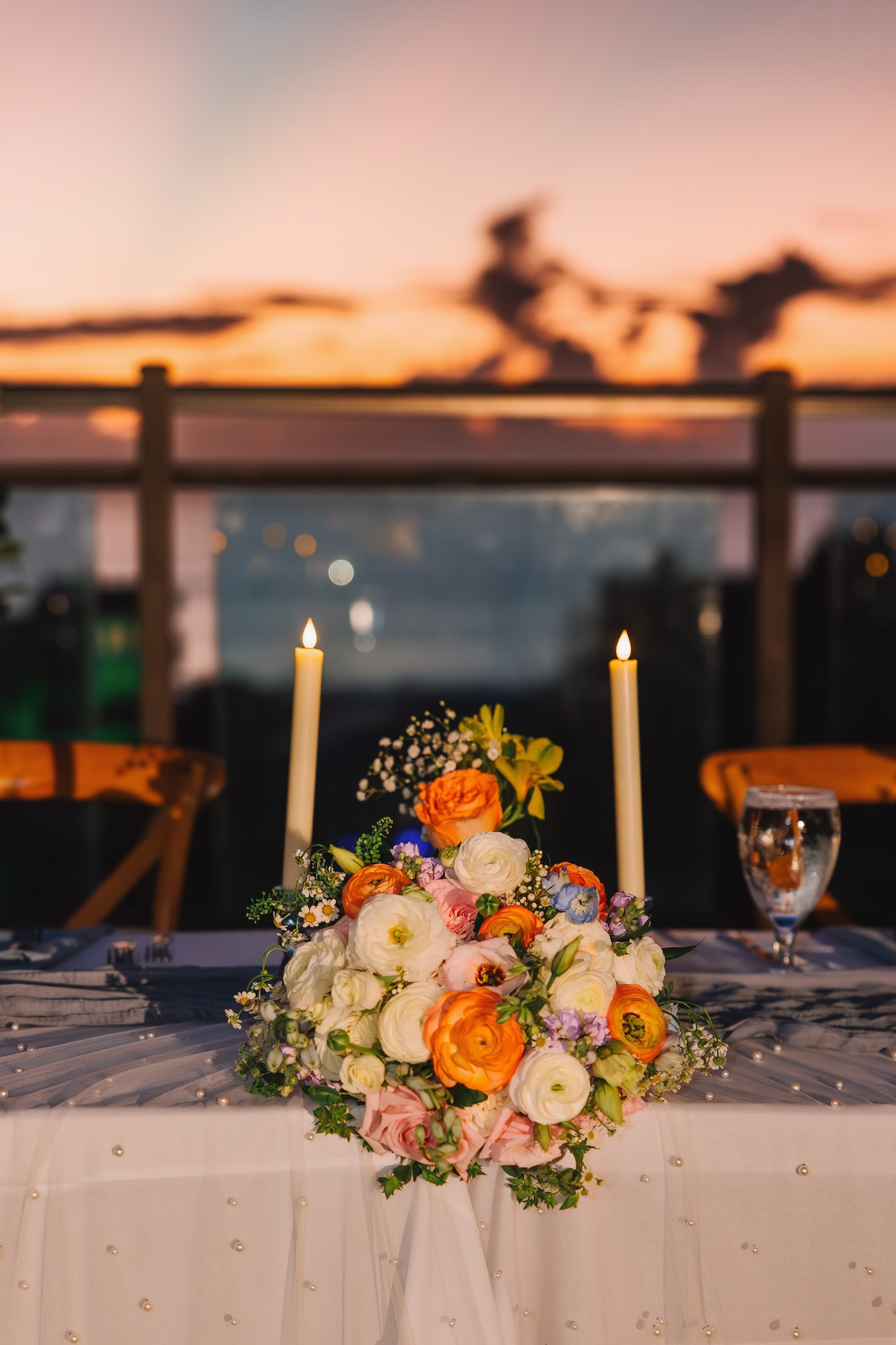 42Coastal Blue and White Rooftop Florida Wedding Ideas - Romantic Blue Coastal St. Pete Beach Wedding | The Hotel Zamora Coastal Elegant Nighttime Waterfront Rooftop Wedding Reception Inspiration | Long Feasting Table with White Taper Candles Tablescape decor Ideas | Lush Romantic Garden Style Centerpiece with Soft Pastel Florals of Pink, Coral and White of Roses and Baby's Breath | Inspiration St Pete Beach Wedding Venue Hotel Zamora | St Petersburg Wedding Planner Seashine Weddings