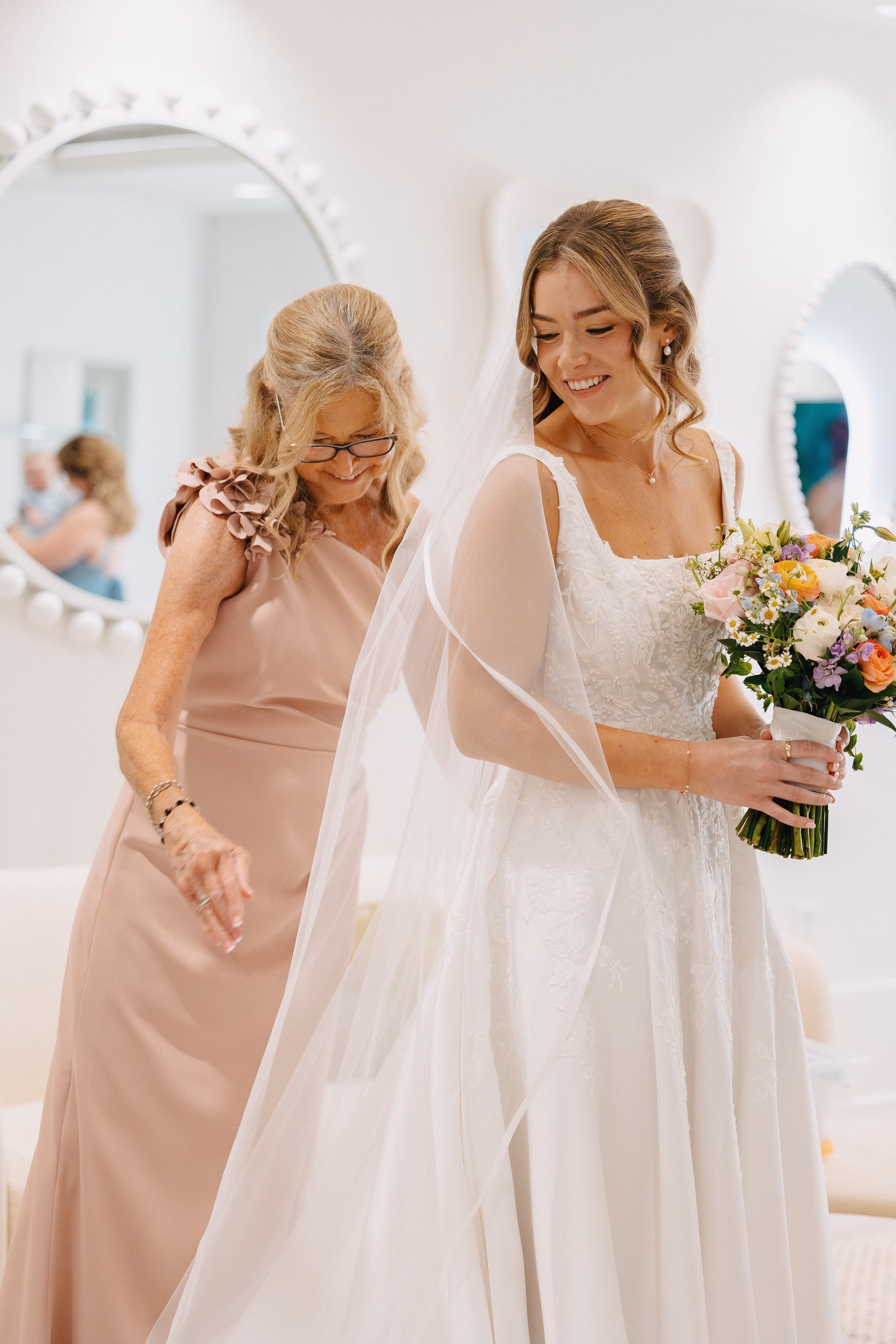 7Coastal Blue and White Rooftop Florida Wedding Ideas - Romantic Blue Coastal St. Pete Beach Wedding | The Hotel Zamora Bride and Mother Getting Ready Wedding Portrait | Classic Half Up Half Down Bridal Hair with Veil Inspiration | Elegant White Magnolia White A-Line Wedding Gown with Square Neckline and Full Skirt Ideas | Sarasota Hair and Makeup Artist Femme Akoi Beauty Studio
