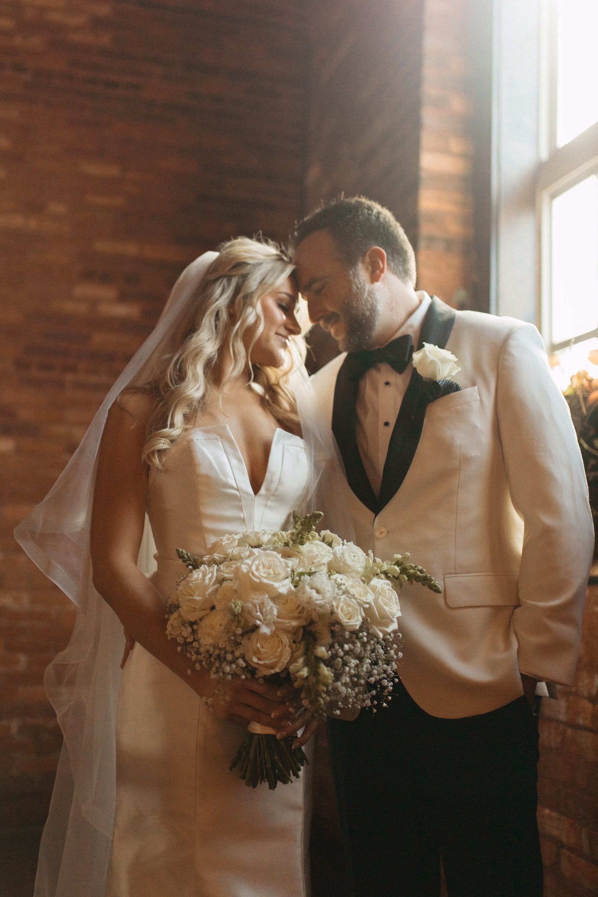 Bride and Groom Wedding Portrait | Classic White Floral Bridal Bouquet with Greenery Inspiration | White Roses and White Baby's Breath with Satin Ribbon Bouquet Ideas | Clearwater Florist Lemon Drops Wedding and Events