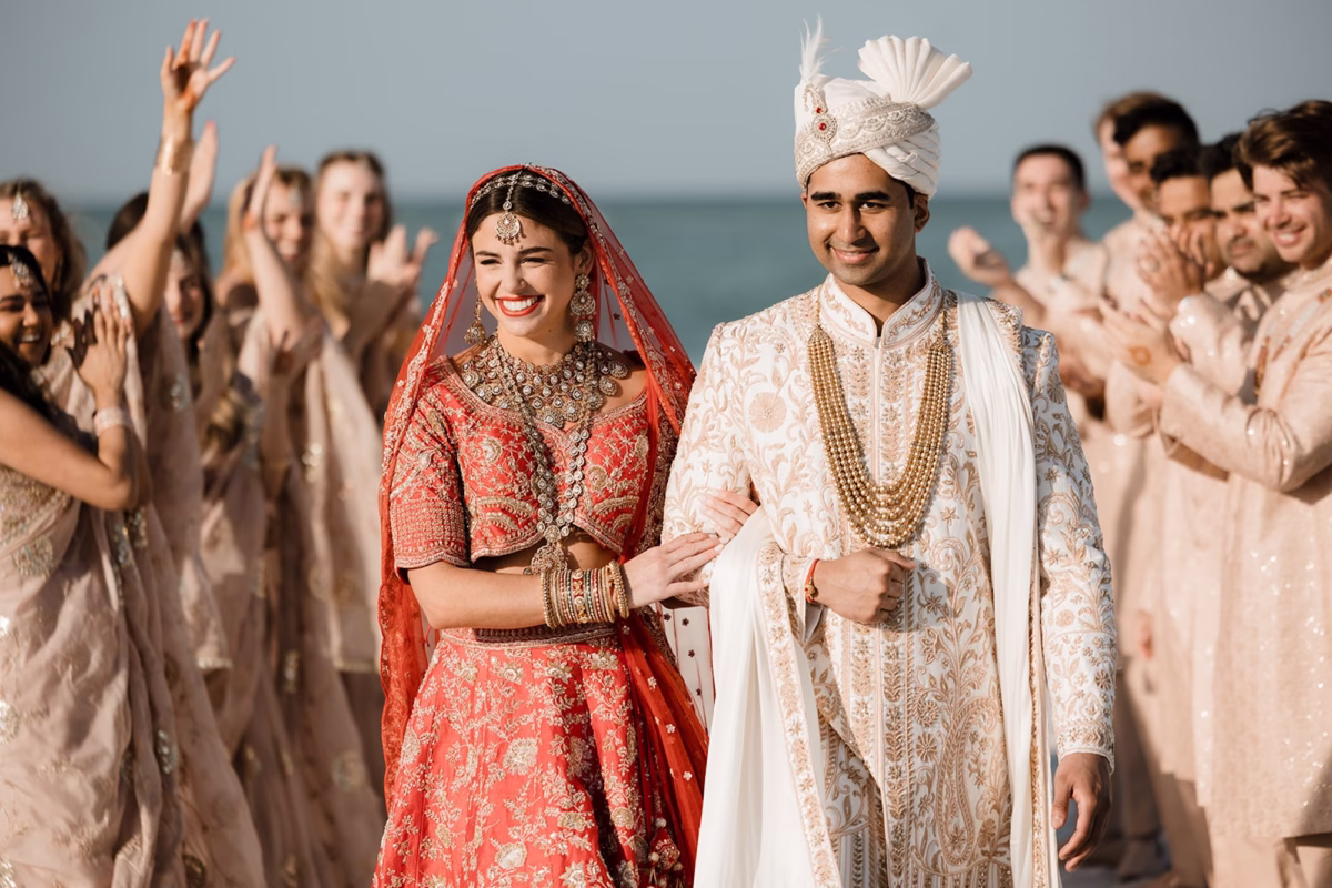 17Tropical Pink and Red Sarasota Beach Indian Wedding Ceremony - Vibrant Pink and Gold Multicultural Sarasota Wedding | Powel Crosley Estate Bride and Groom Just Married Wedding Portrait | Bright Red and Gold Bride Lehenga by Kalighata at Kynah Ideas | Groom Beaded Off-White Sherwani Inspiration | Indian Culture Wedding Ideas | Photographer Evoke Photo and Film
