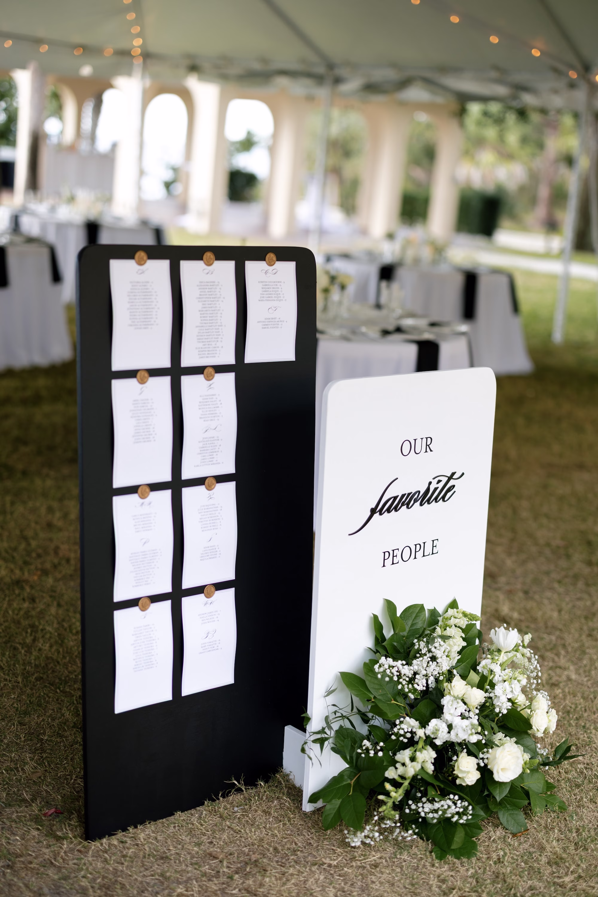 Simple Black and White Wedding Reception Seating Chart with Gold Wax Seals Decor Inspiration | Elegant Black and White Welcome Sign Decor Ideas | White Roses, Hydrangeas, Baby's Breath in Green Eucalyptus Floral Arrangement Decor Inspiration | Tampa Bay Florist Save The Date Florida | Sarasota Planner B Eventful