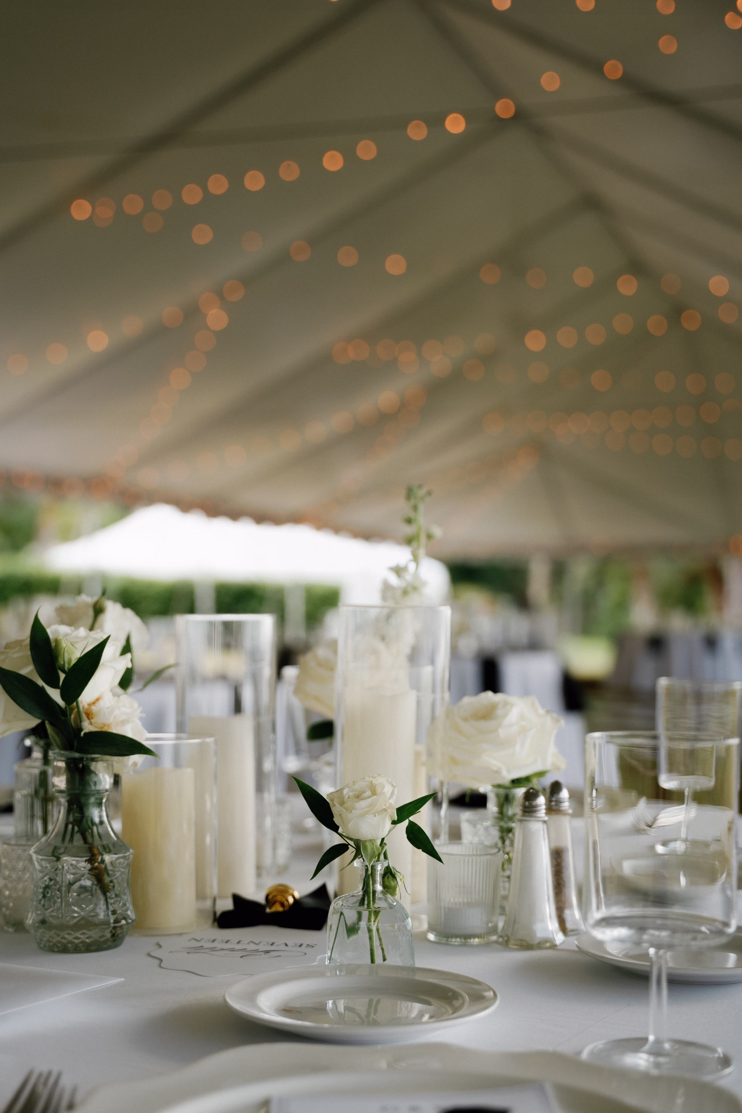 Elegant Black and White Outdoor Fall Tented Florida Wedding Reception Inspiration | Simple Bud Vases with Single Stem White Roses Centerpiece Tablescape Decor Ideas | Tampa Bay Florist Save The Date Florida | Sarasota Planner B Eventful