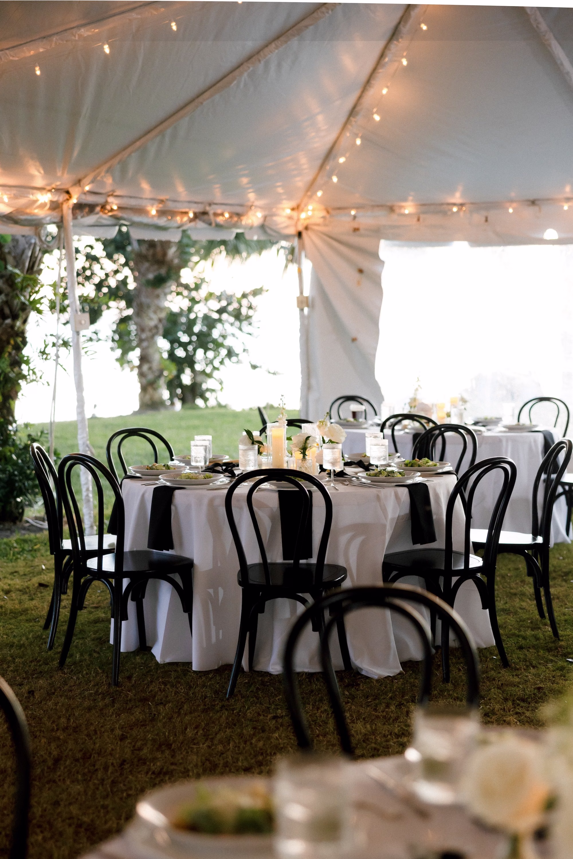 Black and White Outdoor Fall Florida Tented Wedding Inspiration | Black Wedding Reception Chairs Ideas | White Linens with Black Napkins Tablescape Decor Inspiration | Sarasota Planner B Eventful
