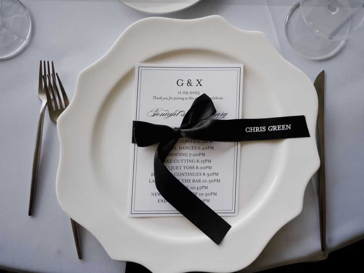 Elegant Simple White Charger with White and Black Menu Card with Black Personalized Bow Tablescape Decor Inspiration | Sarasota Planner B Eventful