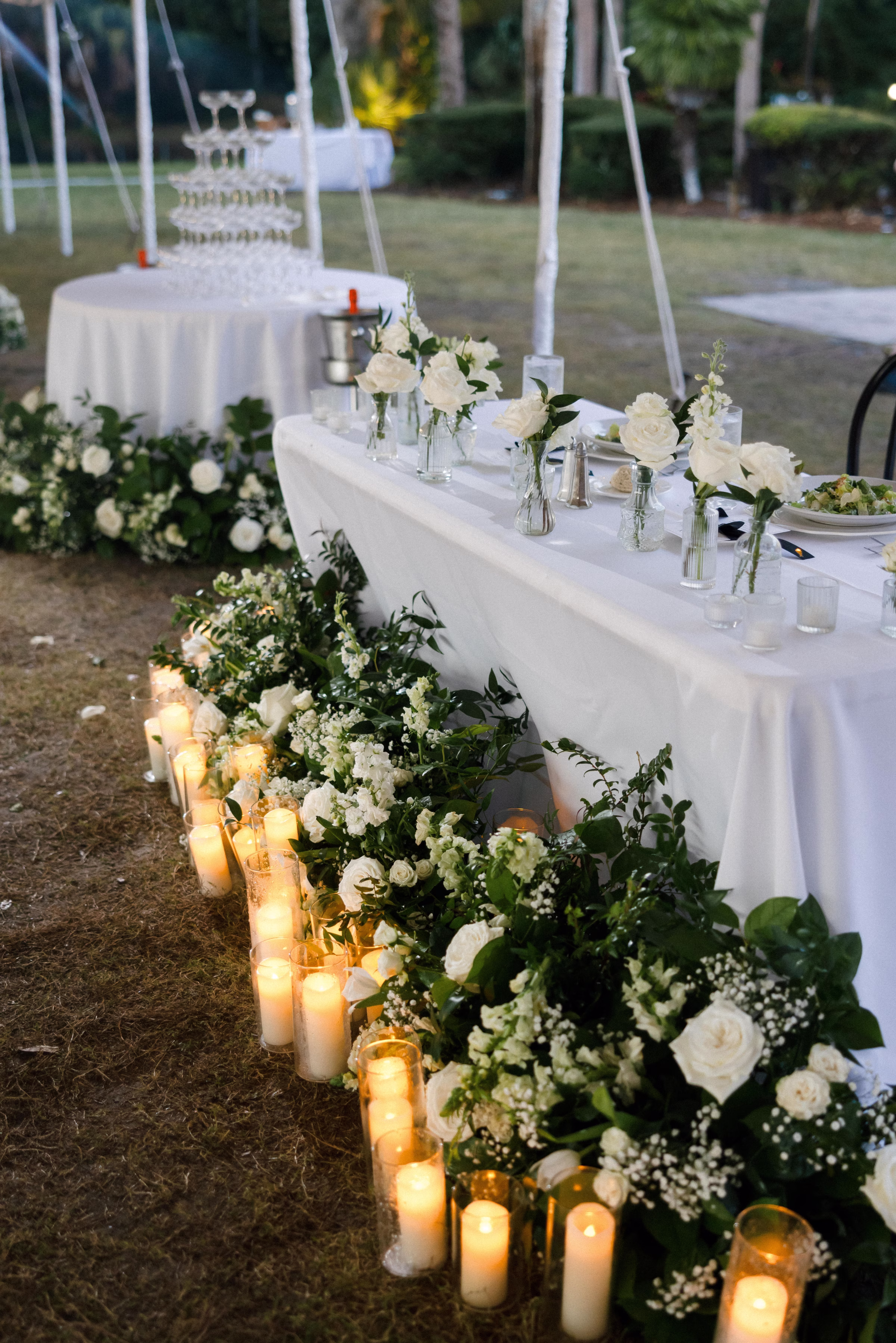 Romantic Candlelight Wedding Reception Decor Ideas | Monochromatic White Roses and Baby's Breath Flower Arrangement Wedding Reception Decor Inspiration | Simple Bud Vases with Single Stem White Roses Centerpiece Decor Ideas | Tampa Bay Florist Save The Date Florida | Sarasota Planner B Eventful