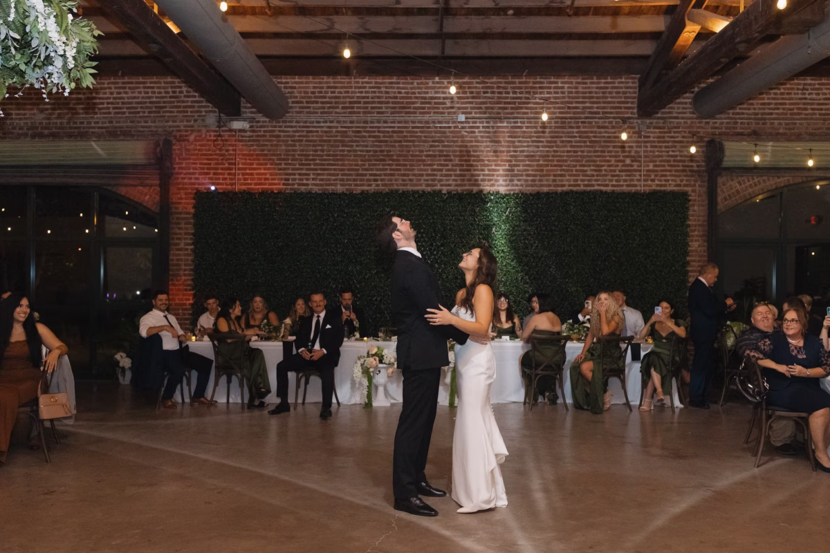41Classic White and Green Florida Wedding Inspiration St Pete Venue Events at Morean Historic Train Station - Classic, White and Green St. Pete Wedding | Events at Morean Historic Train Station Modern Industrial Rustic Exposed Brick Ballroom Wedding Reception | Bride and Groom First Dance Wedding Portrait | Tampa Bay DJ Graingertainment | Venue St. Petersburg Venue Morean Center for Clay