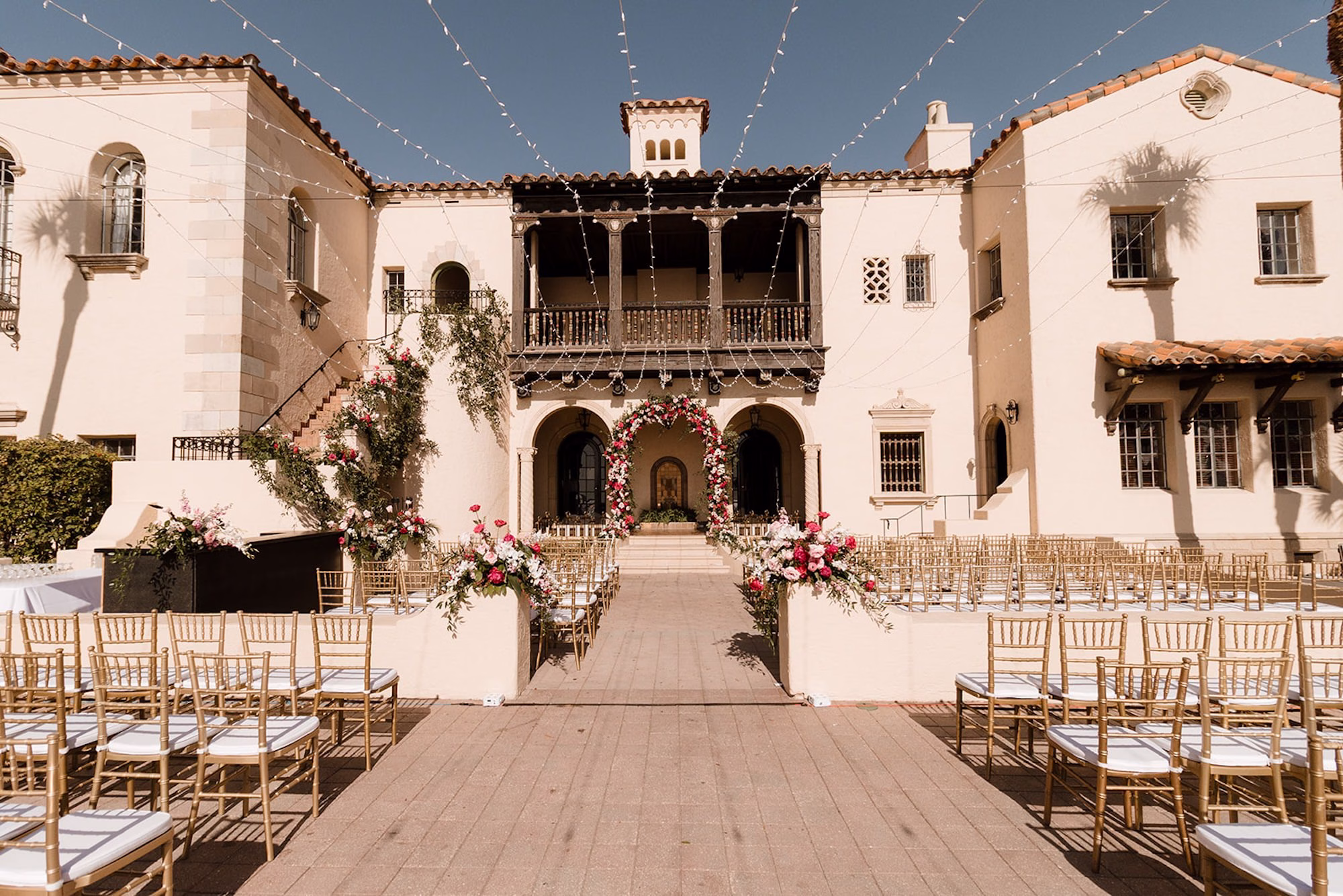 47Romantic Pink and Gold Waterfront Florida Wedding Sarasota Venue Powel Crosley Estate - Vibrant Pink and Gold Multicultural Sarasota Wedding | Powel Crosley Estate Garden Romantic Outdoor Wedding Ceremony | Lush Full-Length Floral Arch with Pink, Red and Blush Roses, Hydrangeas and Greenery Reception Decor Inspiration | Sarasota Wedding Venue Powel Crosley Estate
