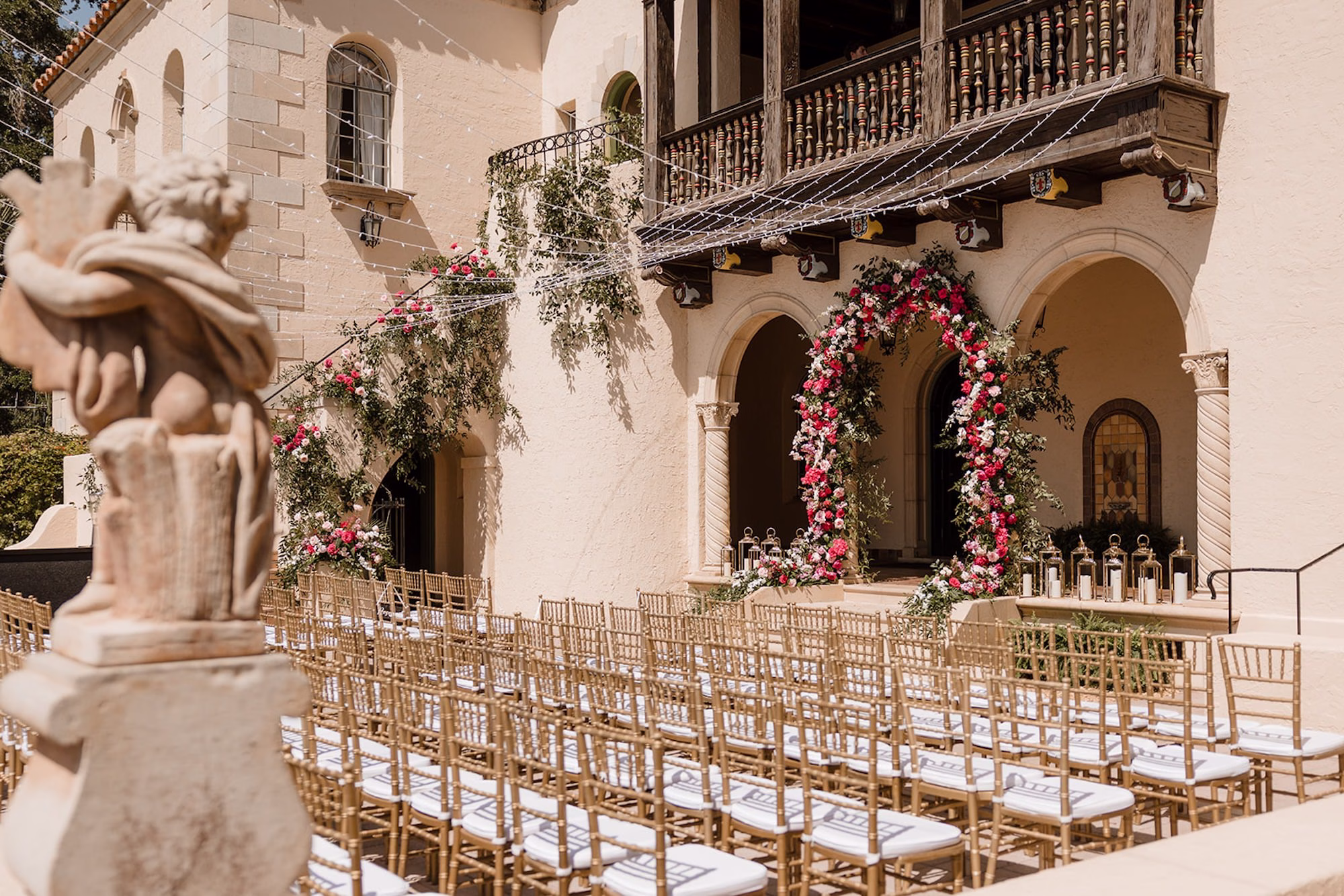 53Romantic Pink and Gold Waterfront Florida Wedding Sarasota Venue Powel Crosley Estate - Vibrant Pink and Gold Multicultural Sarasota Wedding | Powel Crosley Estate Garden Romantic Outdoor Wedding Ceremony | Lush Full-Length Floral Arch with Pink, Red and Blush Roses, Hydrangeas and Greenery Reception Decor Inspiration | String Lights and Gold Ceremony Chairs Decor Ideas | Sarasota Wedding Venue Powel Crosley Estate