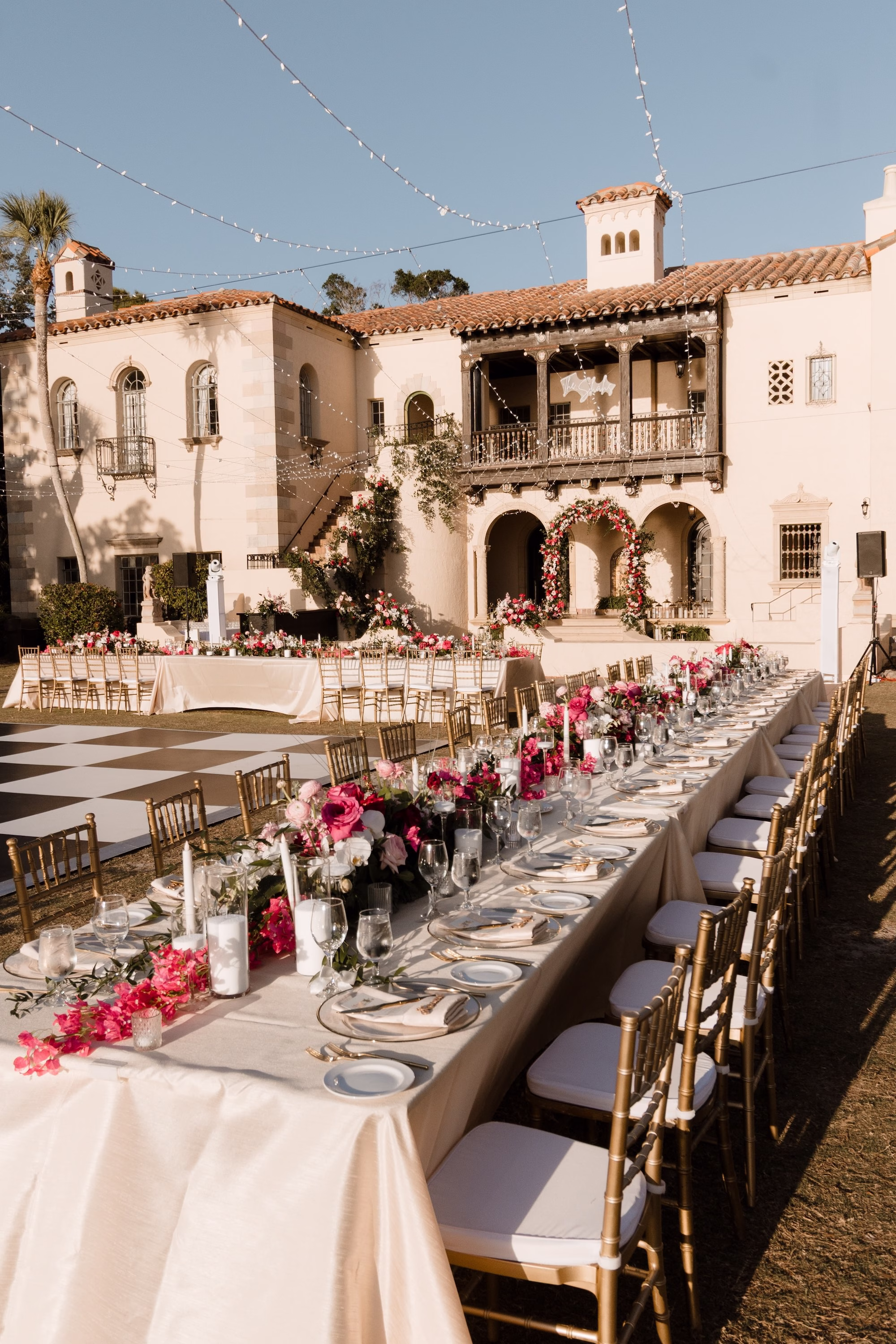 72Romantic Pink and Gold Waterfront Florida Wedding Sarasota Venue Powel Crosley Estate - Vibrant Pink and Gold Multicultural Sarasota Wedding | Powel Crosley Estate Garden Romantic Outdoor Wedding Reception | Lush Long Feasting Table with Pink, Red and Blush Roses, Hydrangeas and Greenery Garland Centerpiece Reception Decor Inspiration | Candlelight Tablescape Decor Ideas | String Lights and Candlelit Table Reception Decor Inspiration | Sarasota Wedding Venue Powel Crosley Estate