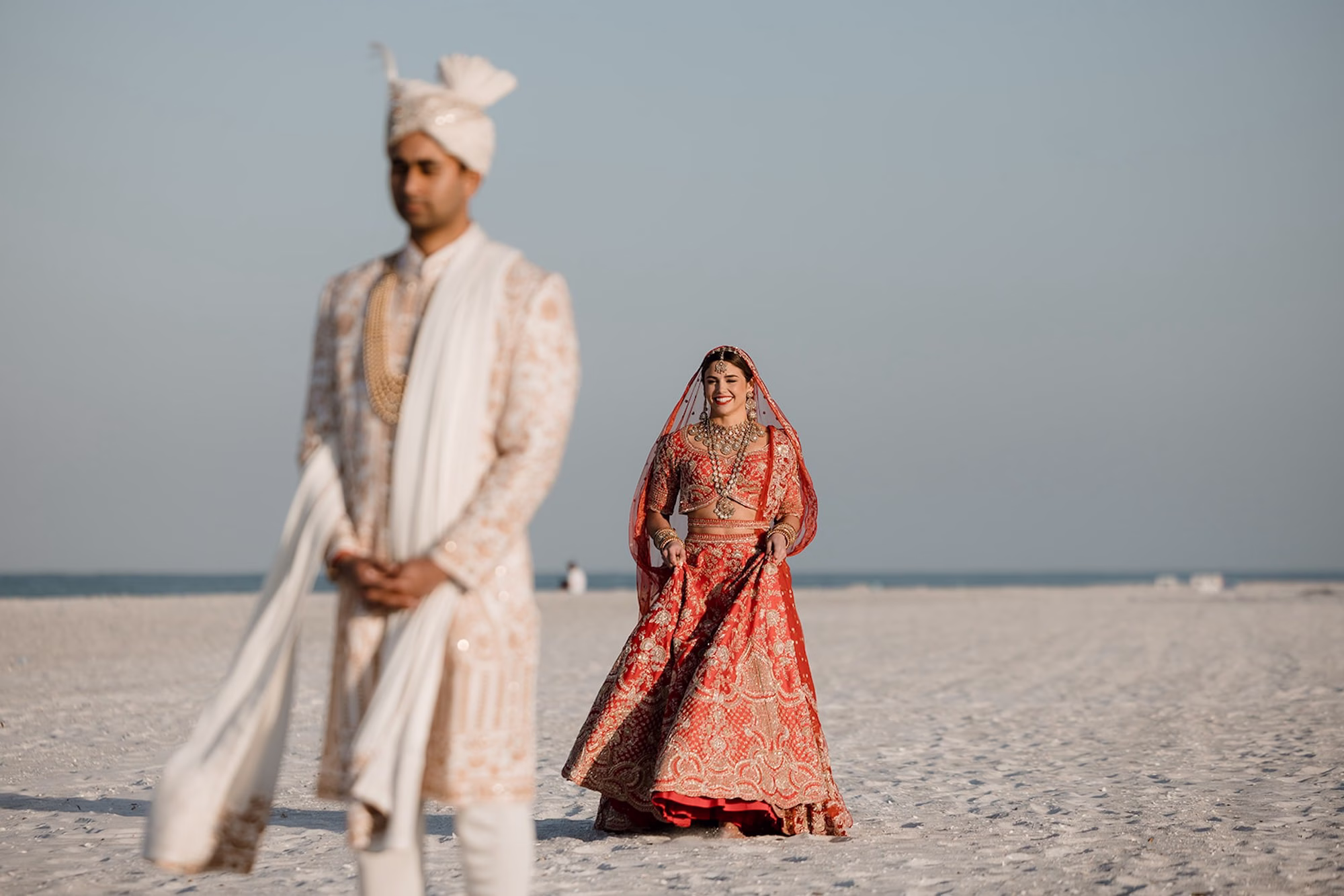 7Tropical Pink and Red Sarasota Beach Indian Wedding Ceremony Venue The Resort at Longboat Key Club - Vibrant Pink and Gold Multicultural Sarasota Wedding | Powel Crosley Estate Bride and Groom First Look on Beach Wedding Portrait | Bright Red and Gold Bride Lehenga by Kalighata at Kynah Ideas | Groom Beaded Off-White Sherwani Inspiration | Indian Culture Wedding Ideas | Sarasota Beach Event Venue The Resort at Longboat Key Club | Photographer Evoke Photo and Film