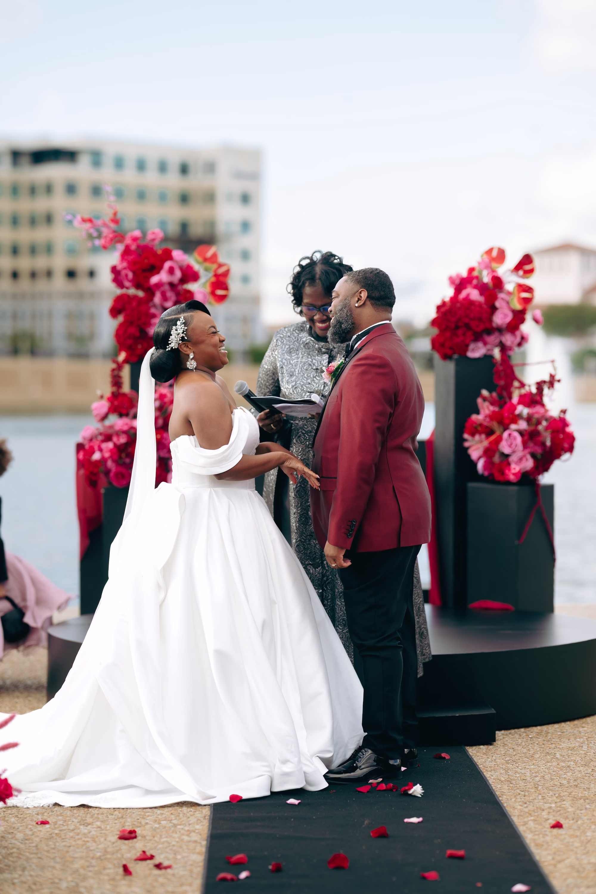 12Bold Pink Red and Burgundy Wedding Ideas - Glamorous, Burgundy Lakeland Wedding | Lake Mirror Amphitheater Bride and Groom Waterfront Wedding Ceremony Vow Exchange Wedding Portrait | Pink, Red, Burgundy Wedding Ceremony Floral Decor Ideas | White Ball Gown with Long Train Inspiration | Lakeland Wedding Ceremony Venue Lake Mirror Amphitheater