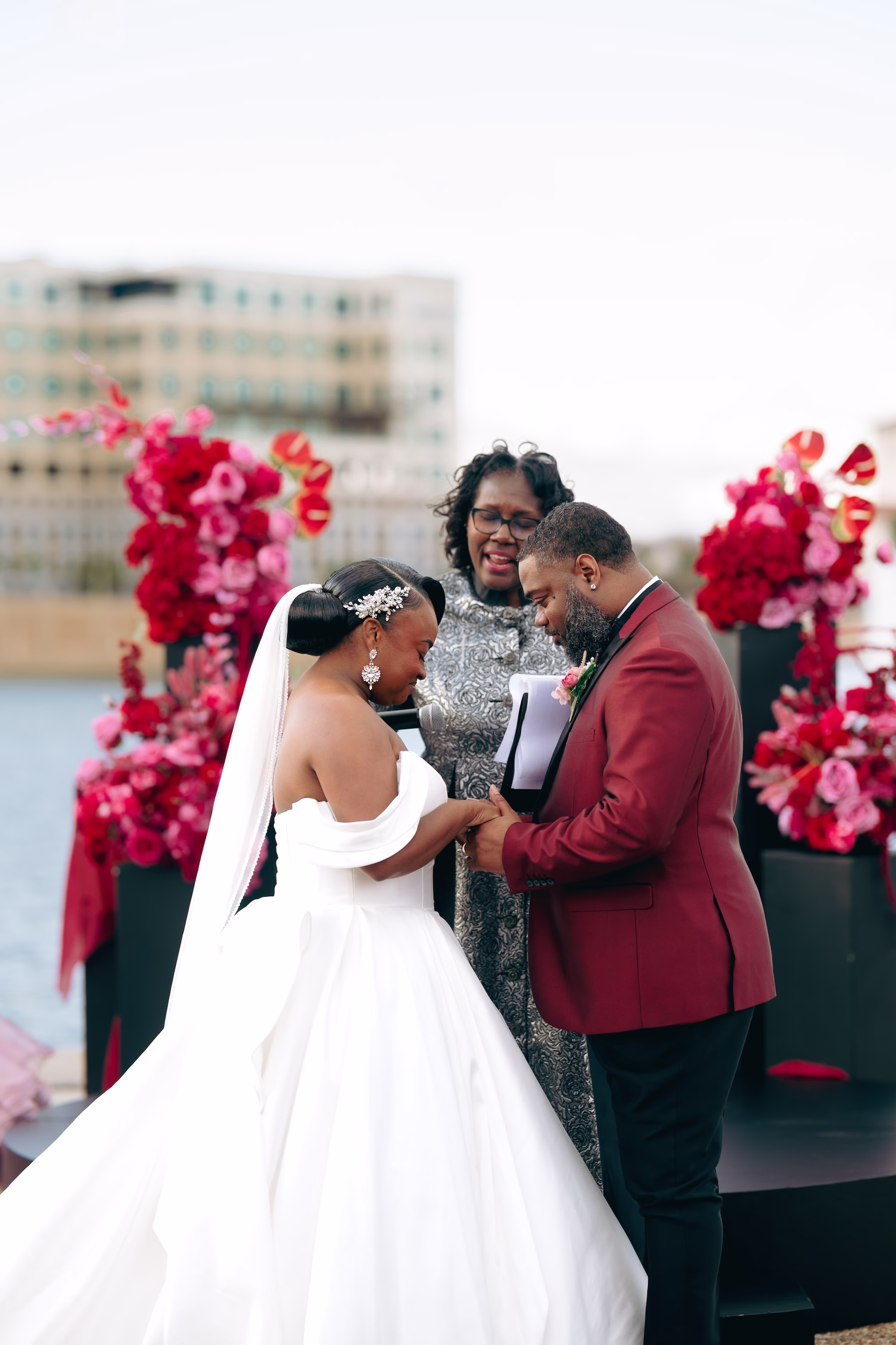 13Bold Pink Red and Burgundy Wedding Ideas - Glamorous, Burgundy Lakeland Wedding | Lake Mirror Amphitheater Bride and Groom Waterfront Wedding Ceremony Vow Exchange Wedding Portrait | Pink, Red, Burgundy Wedding Ceremony Floral Decor Ideas | White Ball Gown with Long Train Inspiration | Lakeland Wedding Ceremony Venue Lake Mirror Amphitheater