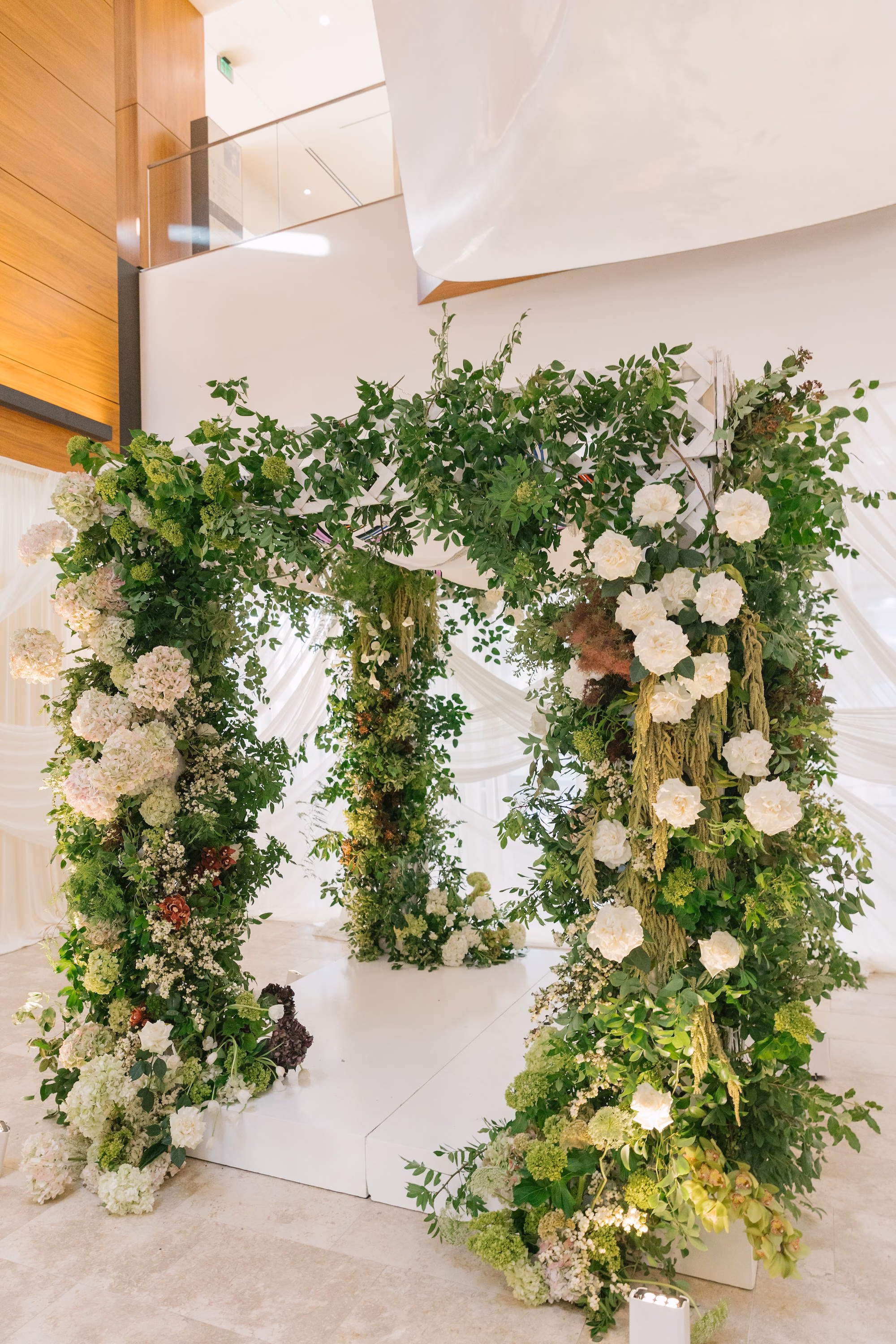 Elegant Minimalist Traditional Jewish Wedding Ceremony Decor Inspiration | Traditional Jewish Wedding Chuppah of Lush Green Foliage and White Hydrangeas and Roses Ideas | St Pete Planner Stelloccasions Weddings and Events