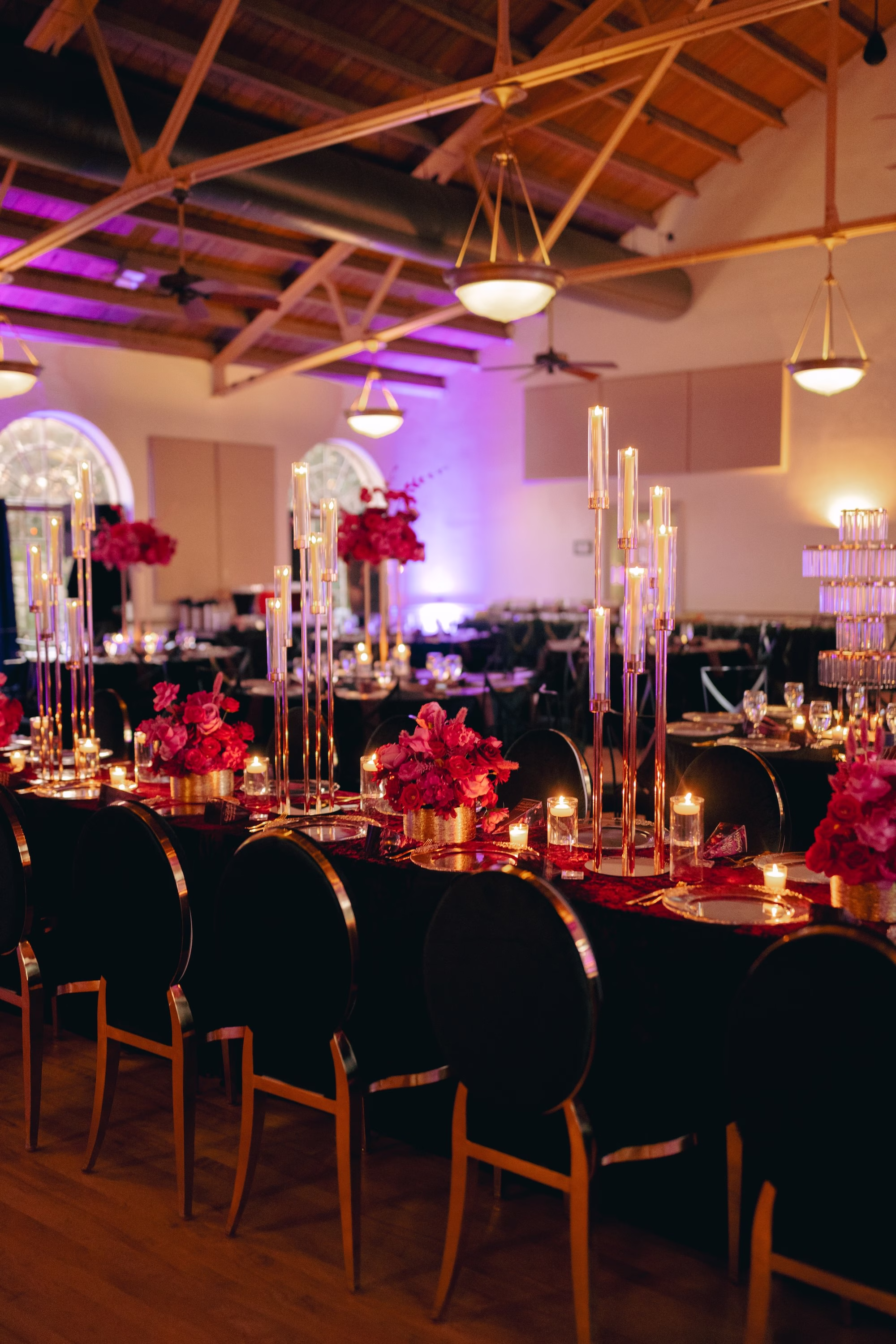 30Bold Pink Red and Burgundy Wedding Ideas - Glamorous, Burgundy Lakeland Wedding | Lake Mirror Amphitheater Glamourous Pink, Red, Burgundy and Black Ballroom Wedding Reception Decor Inspiration | Velvet Burgundy Red Linen with Black Velvet and Gold Chairs Reception Decor Ideas | Hot Pink, Deep Red and Blush Roses Floral Centerpiece Decor Inspiration | Tall Gold Taper Candleholder Decor Ideas | Clear Glass Charger with Gold Rims and Black Napkins in Gold Napkin Ring Tablescape Decor Inspiration