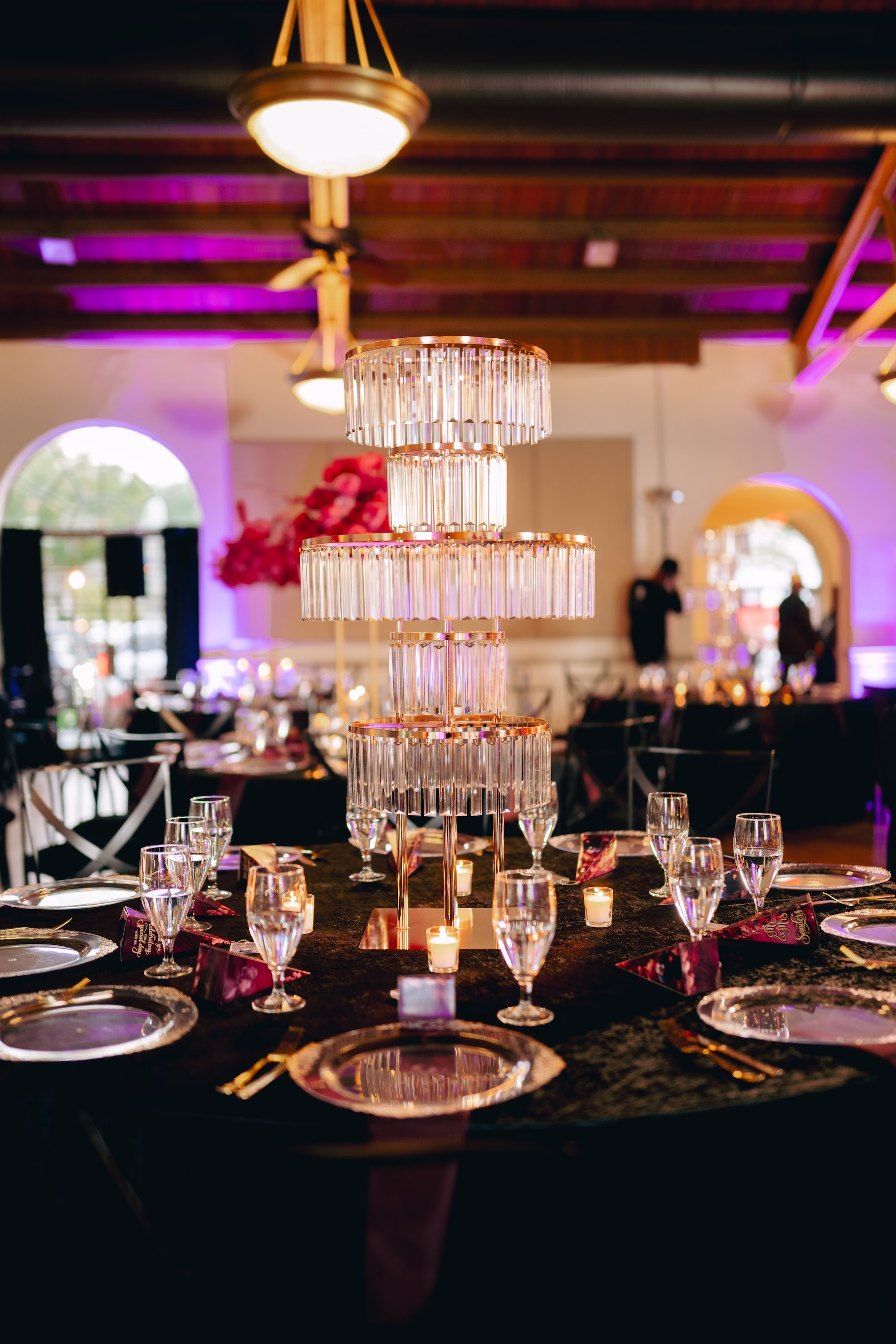 34Bold Pink Red and Burgundy Wedding Ideas - Glamorous, Burgundy Lakeland Wedding | Lake Mirror Amphitheater Glamourous Pink, Red, Burgundy and Black Ballroom Wedding Reception Decor Inspiration | Multi-Tiered Crystal Tube Chandelier Wedding Reception Centerpiece Decor Ideas | Black Velvet Table Linens Decor Inspiration | Clear Glass Charger with Gold Rims and Black Napkins in Gold Napkin Ring Tablescape Decor Ideas