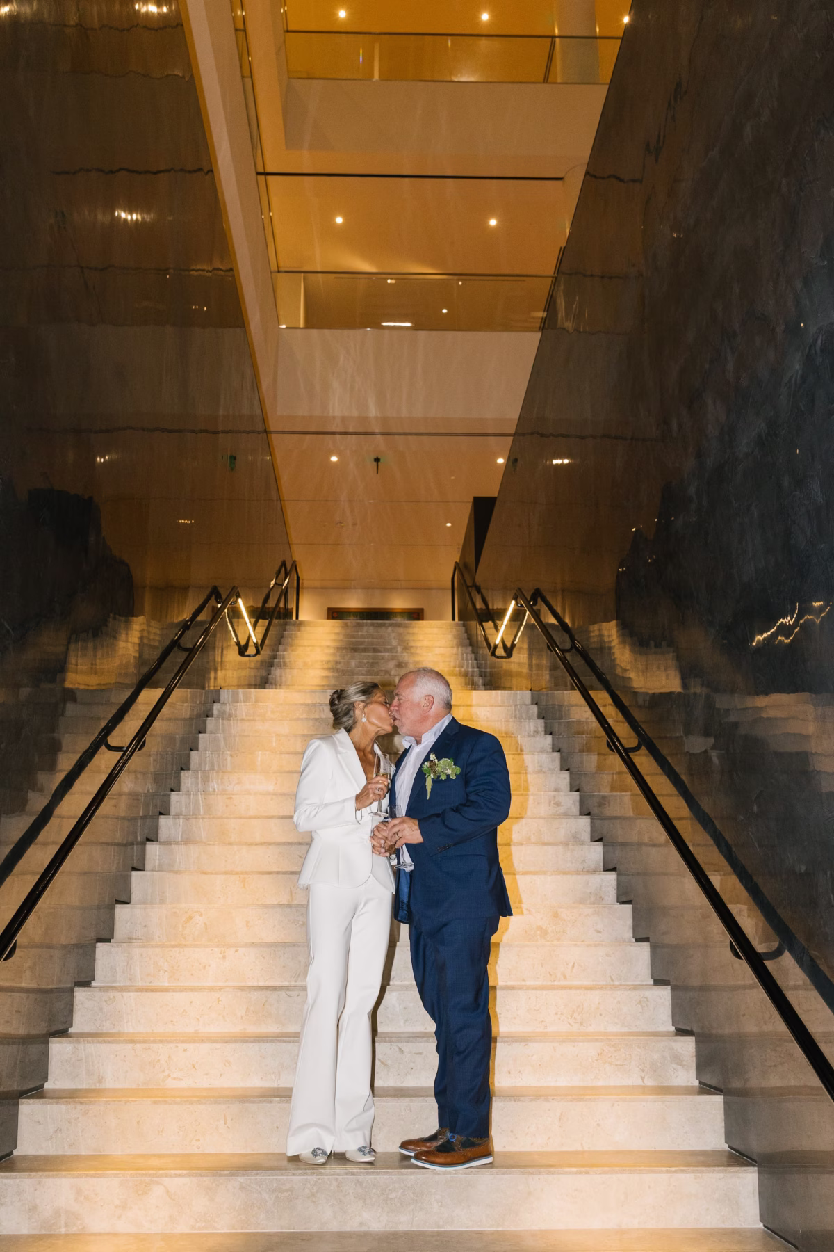 Bride and Groom Wedding Portrait on Staircase of Wedding Event Venue St Pete Event Venue Museum of the American Arts and Crafts Movement | Modern White Alice and Olivia Wedding Bridal Suit Ideas