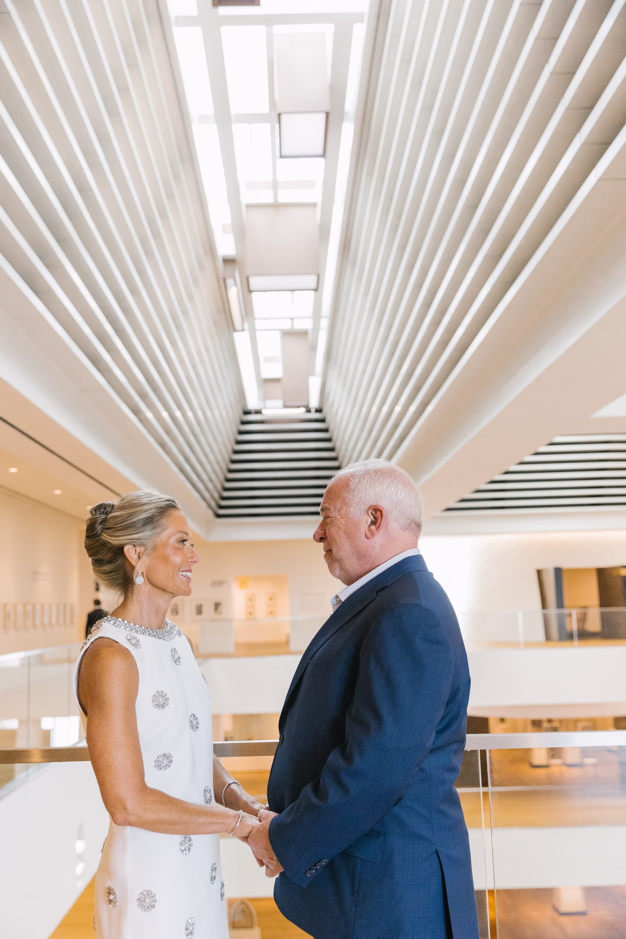 Bride and Groom Wedding Portrait in front of Staircase of Wedding Event Venue St Pete Event Venue Museum of the American Arts and Crafts Movement | Modern Short Halter Style Neckline White Wedding Dress with Intricate 3D Floral Appliqués Ideas