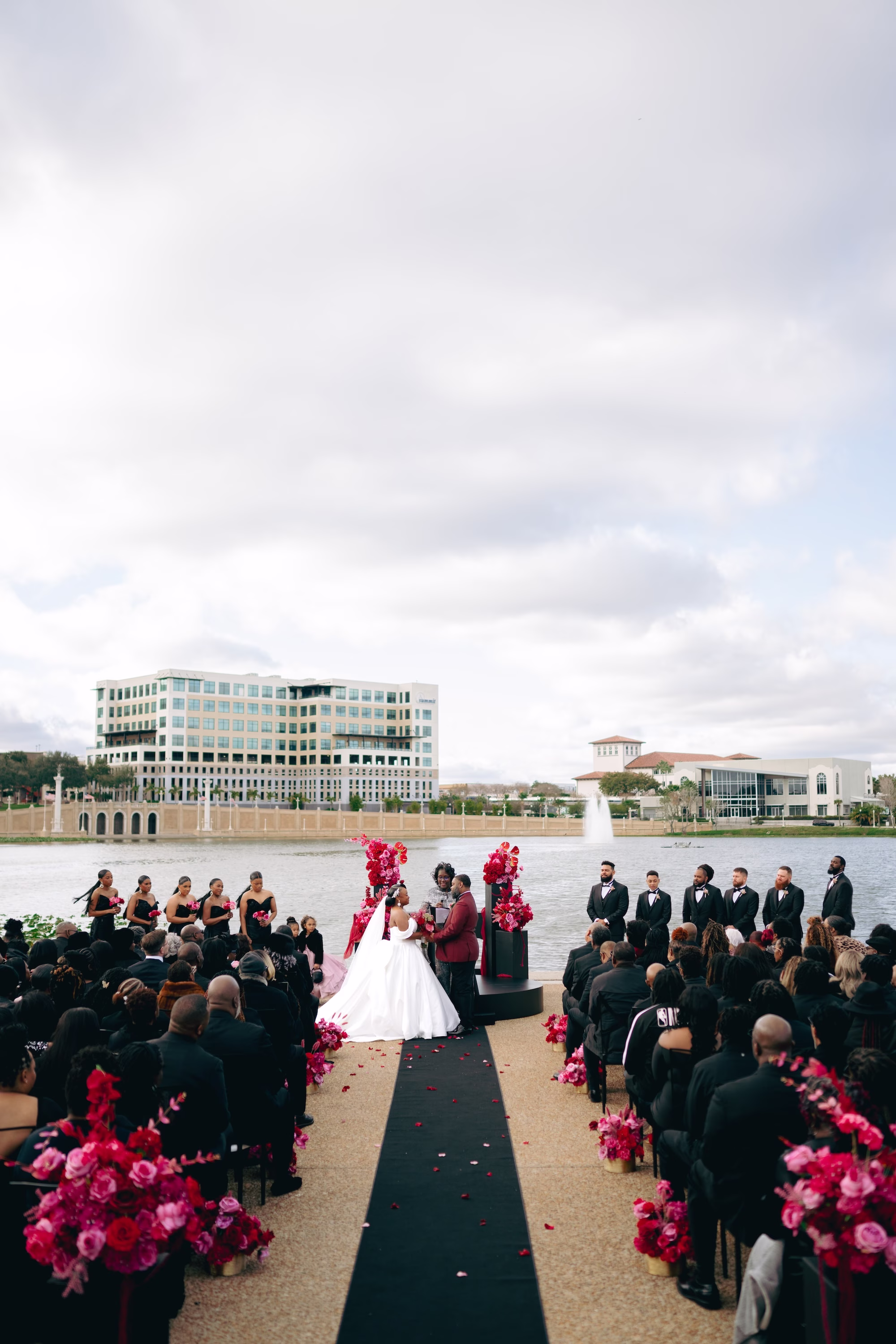 9Bold Pink Red and Burgundy Wedding Ideas Lakeland Wedding Venue Lake Mirror Amphitheater - Glamorous, Burgundy Lakeland Wedding | Lake Mirror Amphitheater Bride and Groom Waterfront Wedding Ceremony Vow Exchange Wedding Portrait | Pink, Red, Burgundy Wedding Ceremony Floral Decor Ideas | White Ball Gown with Long Train Inspiration | Lakeland Wedding Ceremony Venue Lake Mirror Amphitheater