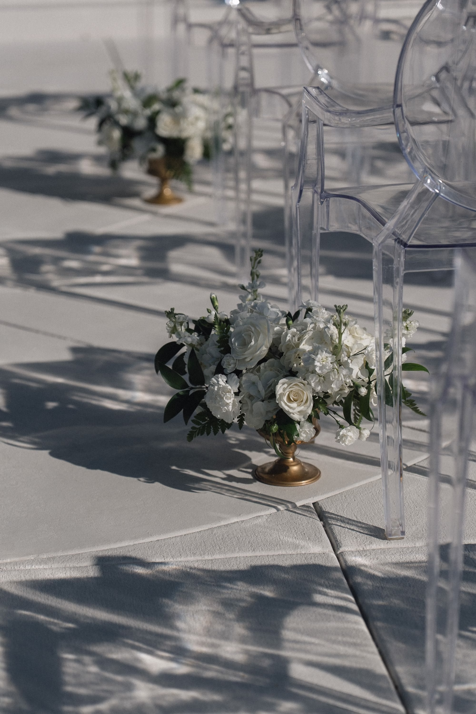 16Timeless Black and Wedding New Years Eve Wedding Ideas - Timeless Black and White Tarpon Springs Wedding | Whitehurst Gallery Monochromatic White Roses, Hydrangeas and Baby's Breath in Gold Vases Wedding Ceremony Aisle Decor Inspiration