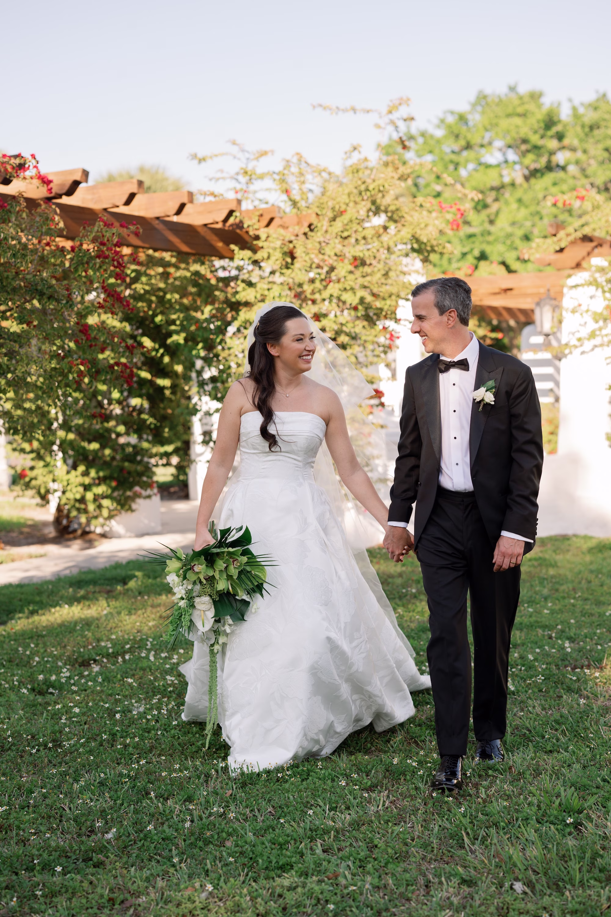 22Tropical Green Florida Wedding Ideas - Tropical, Green Downtown St. Pete Wedding | Poynter Institute Bride and Groom Spring Outdoor Wedding Portrait | White Orchid and Floral Wedding Bridal Bouquet with Large Tropical Palm Greenery Inspiration | Slicked Back Half Up Hair Down Curled Wedding Bridal Hair Ideas | Florida Hair and Makeup Adore Bridal | Tampa Bay Photographer Dewitt For Love