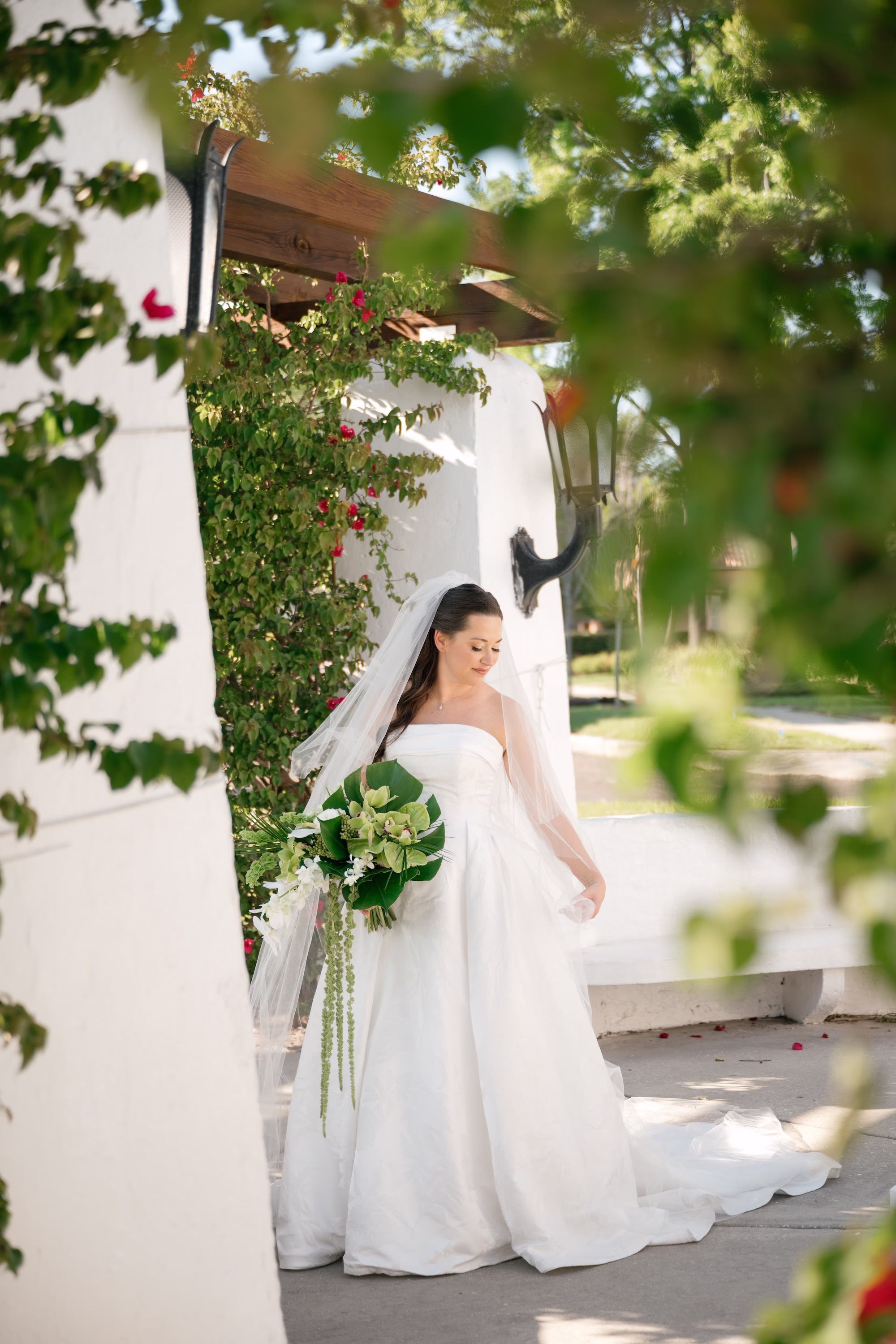 23Tropical Green Florida Wedding Ideas Pete Straub Park - Tropical, Green Downtown St. Pete Wedding | Poynter Institute Bride Wedding Portrait | White Orchid and Floral Wedding Bridal Bouquet with Large Tropical Palm Greenery Inspiration | Slicked Back Half Up Hair Down Curled Wedding Bridal Hair Ideas | Florida Hair and Makeup Adore Bridal | Tampa Bay Photographer Dewitt For Love