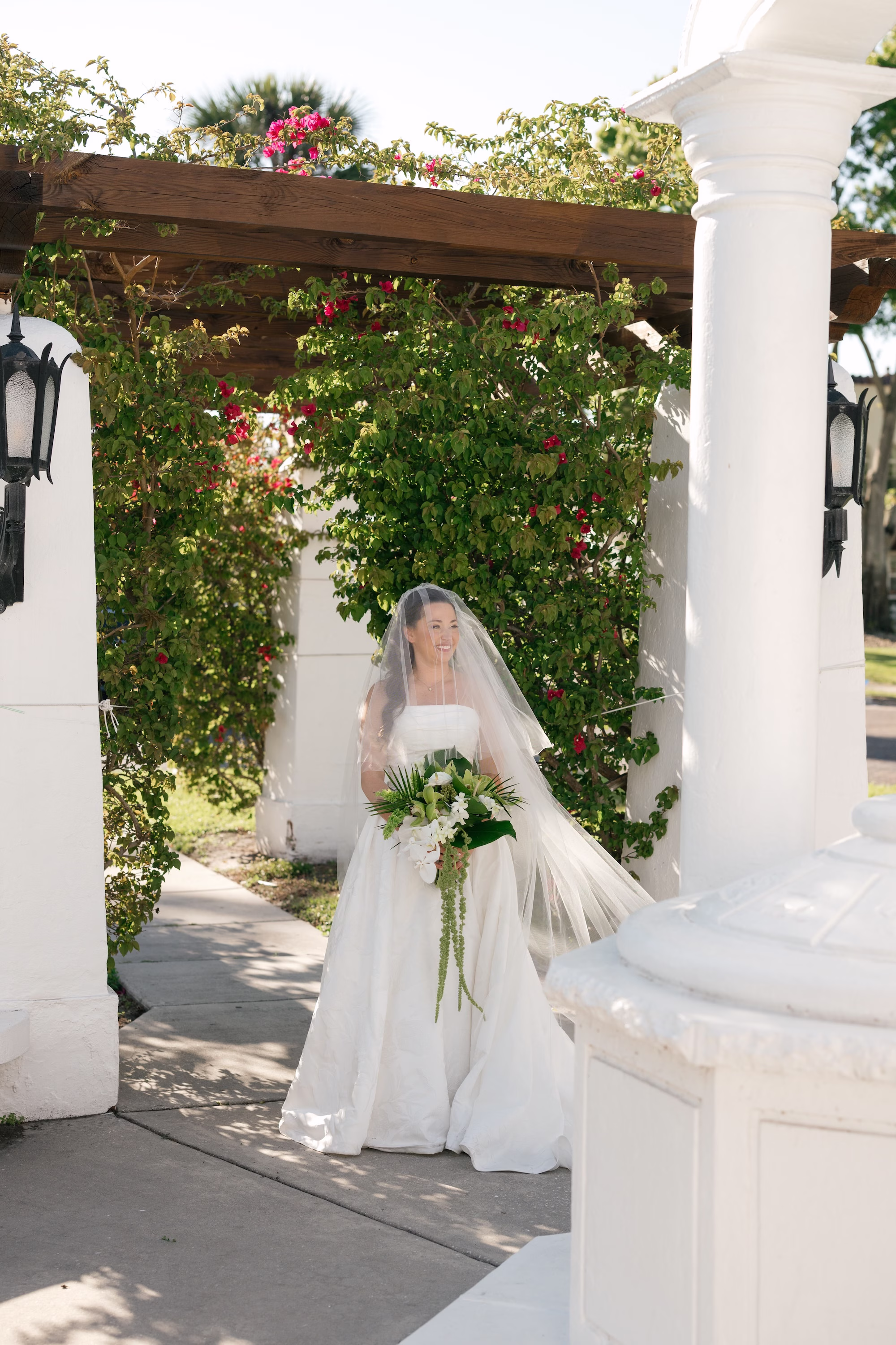 25Tropical Green Florida Wedding Ideas Pete Straub Park - Tropical, Green Downtown St. Pete Wedding | Poynter Institute Bride Wedding Portrait | White Orchid and Floral Wedding Bridal Bouquet with Large Tropical Palm Greenery Inspiration | Slicked Back Half Up Hair Down Curled Wedding Bridal Hair Ideas | Florida Hair and Makeup Adore Bridal | Tampa Bay Photographer Dewitt For Love
