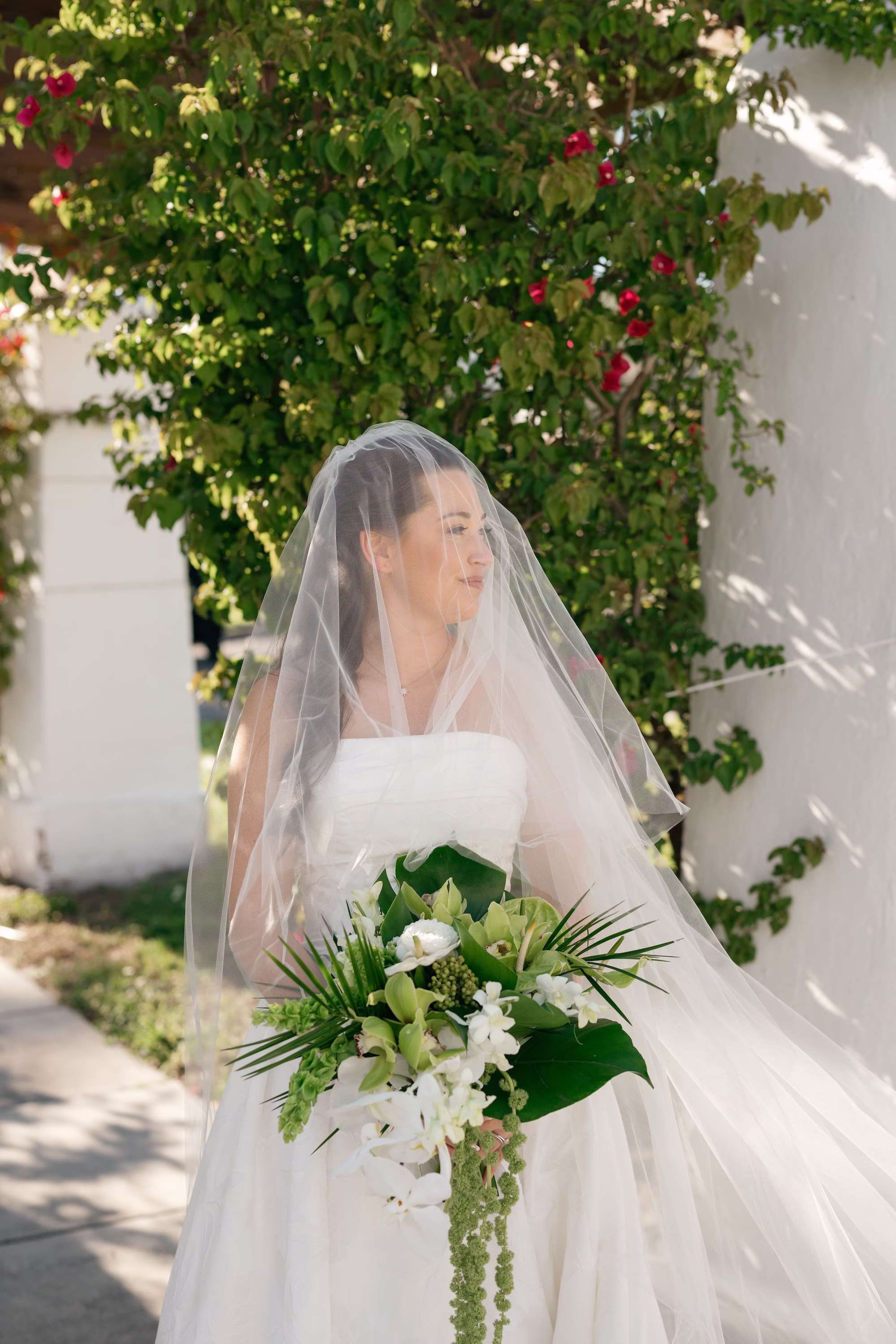 26Tropical Green Florida Wedding Ideas - Tropical, Green Downtown St. Pete Wedding | Poynter Institute Bride Wedding Portrait | White Orchid and Floral Wedding Bridal Bouquet with Large Tropical Palm Greenery Inspiration | Slicked Back Half Up Hair Down Curled Wedding Bridal Hair Ideas | Florida Hair and Makeup Adore Bridal | Tampa Bay Photographer Dewitt For Love