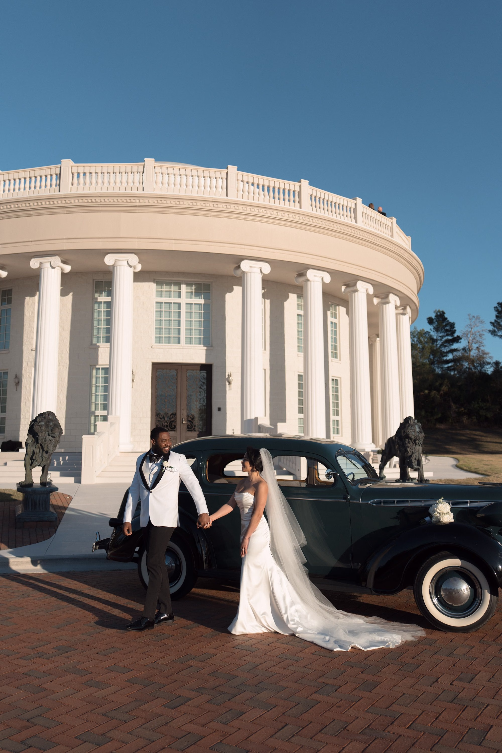 Bride and Groom with Classic Black Rolls Royce Wedding Portrait | White Grooms Tuxedo Attire Inspiration | White Fitted Strapless Ines DiSanto Wedding Gown Inspiration | Tarpon Springs Event Venue Whitehurst Gallery | Tampa Bay Photographer Amber Yonker Photography