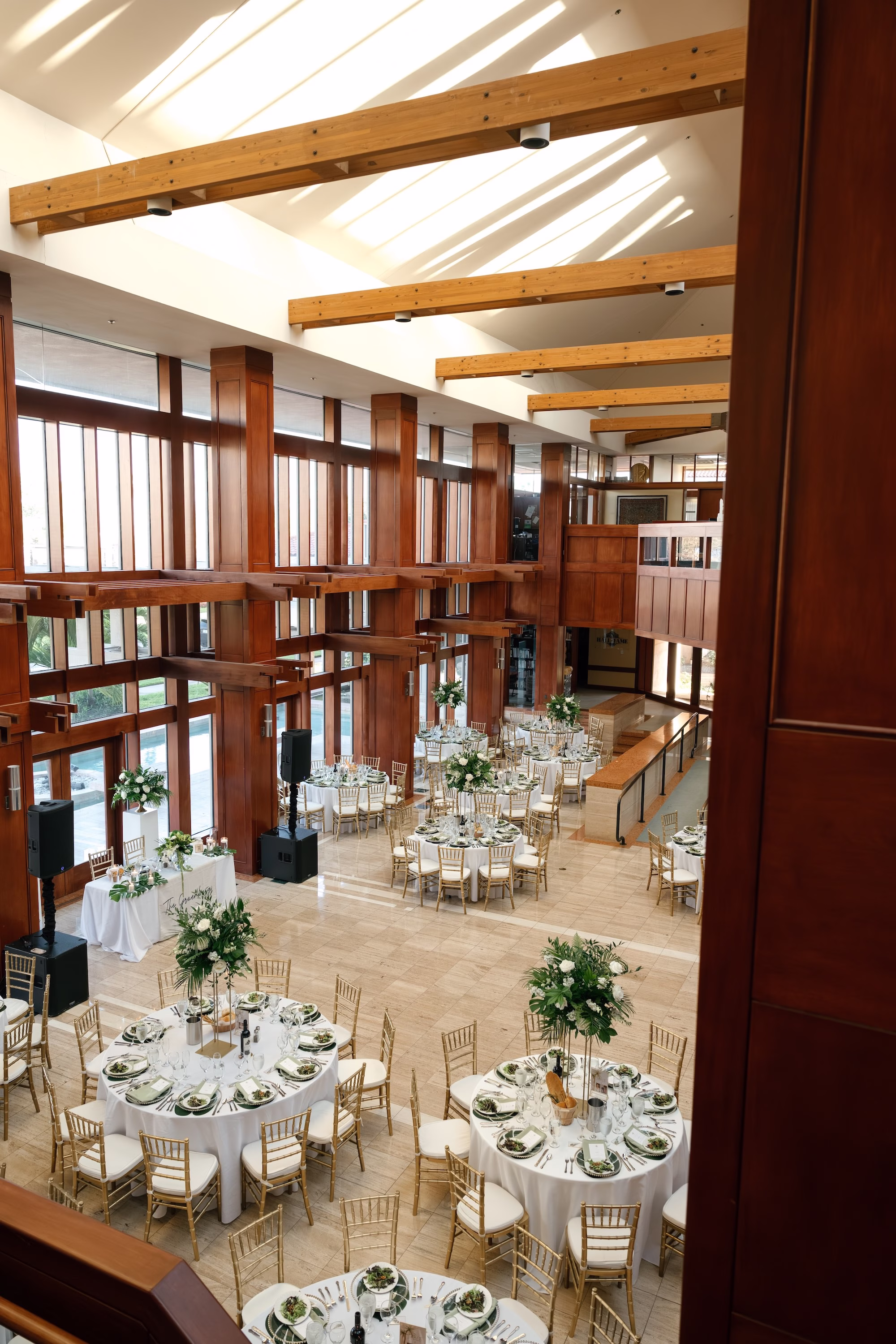 34Tropical Green Florida Wedding Ideas St Pete Venue Poytner Institute - Tropical, Green Downtown St. Pete Wedding | Poynter Institute Tropical Green and White Luxurious Ballroom Wedding Reception | Modern Gold Chiavari Chairs | Tall Gold Platform Centerpieces with White Florals and Greenery Arrangement Ideas | St Pete Event Planner Coastal Coordinating | Florida Venue Poynter Institute