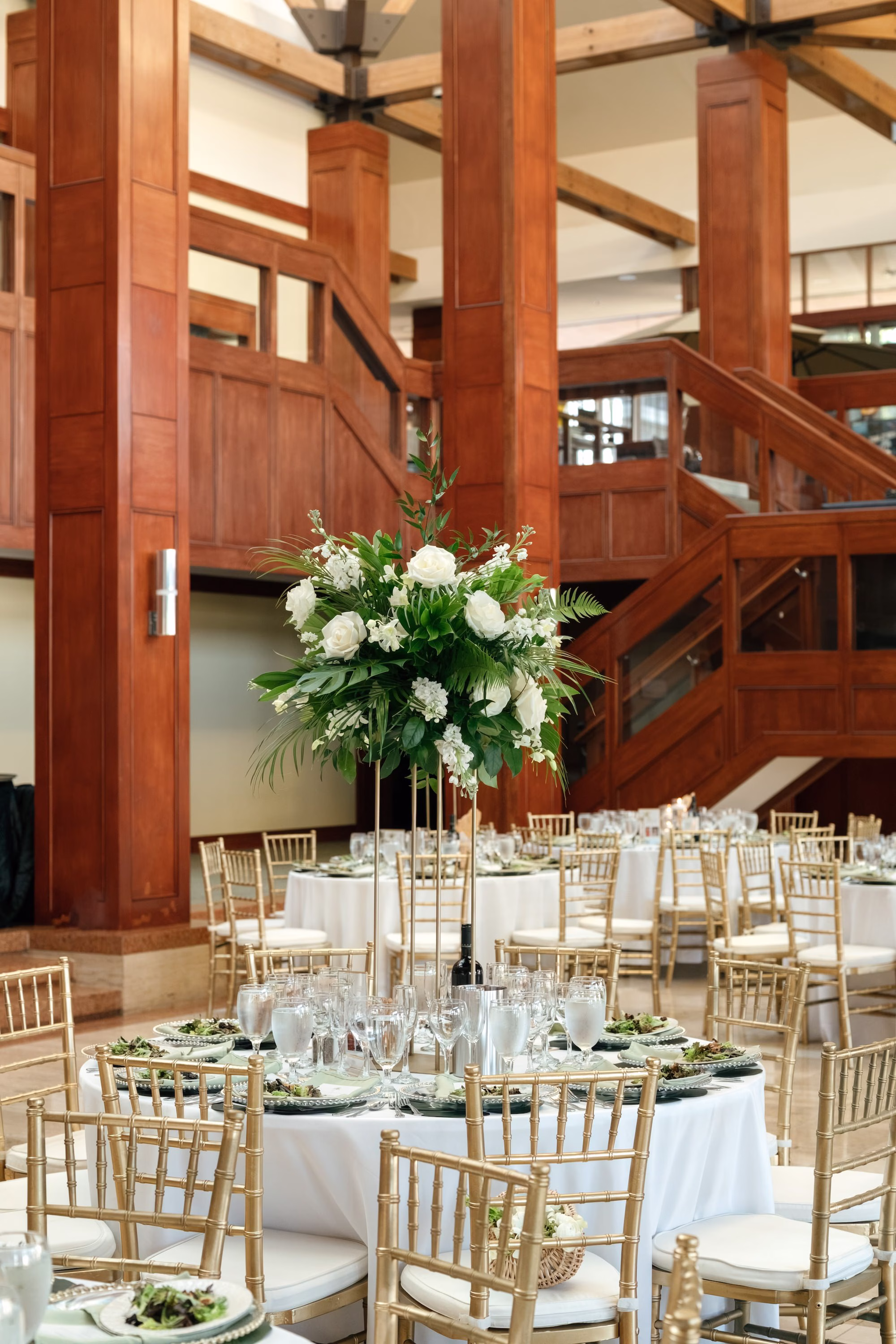 42Tropical Green Florida Wedding Ideas - Tropical, Green Downtown St. Pete Wedding | Poynter Institute Tropical Green and White Luxurious Ballroom Wedding Reception | Modern Gold Chiavari Chairs | Tall Gold Platform Centerpieces with White Florals and Greenery Arrangement Ideas | St Pete Event Planner Coastal Coordinating | Florida Venue Poynter Institute