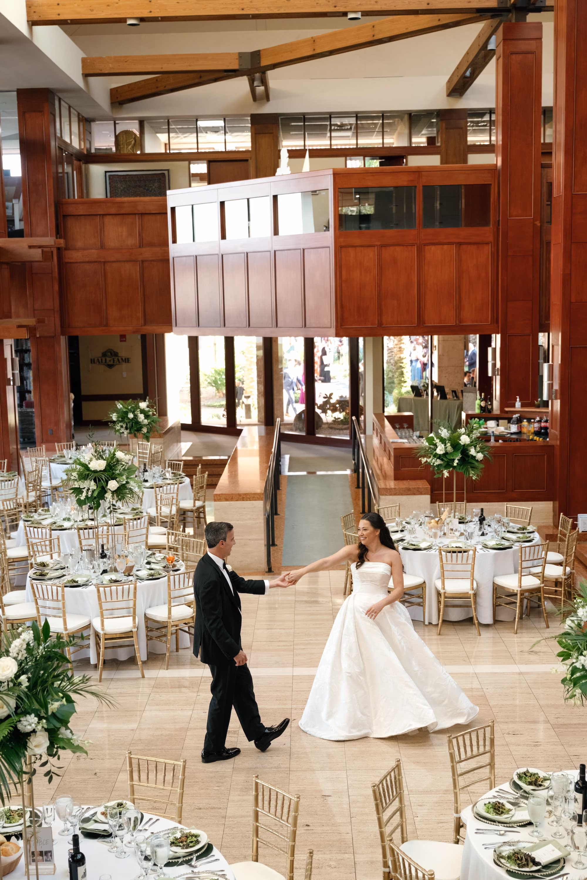 45Tropical Green Florida Wedding Ideas St Pete Venue Poytner Institute - Tropical, Green Downtown St. Pete Wedding | Poynter Institute Bride and Groom First Dance Wedding Portrait | Tropical Green and White Luxurious Ballroom Wedding Reception | Modern Gold Chiavari Chairs | Tall Gold Platform Centerpieces with White Florals and Greenery Arrangement Ideas | St Pete Event Planner Coastal Coordinating | Florida Venue Poynter Institute | Tampa Bay Photographer Dewitt For Love