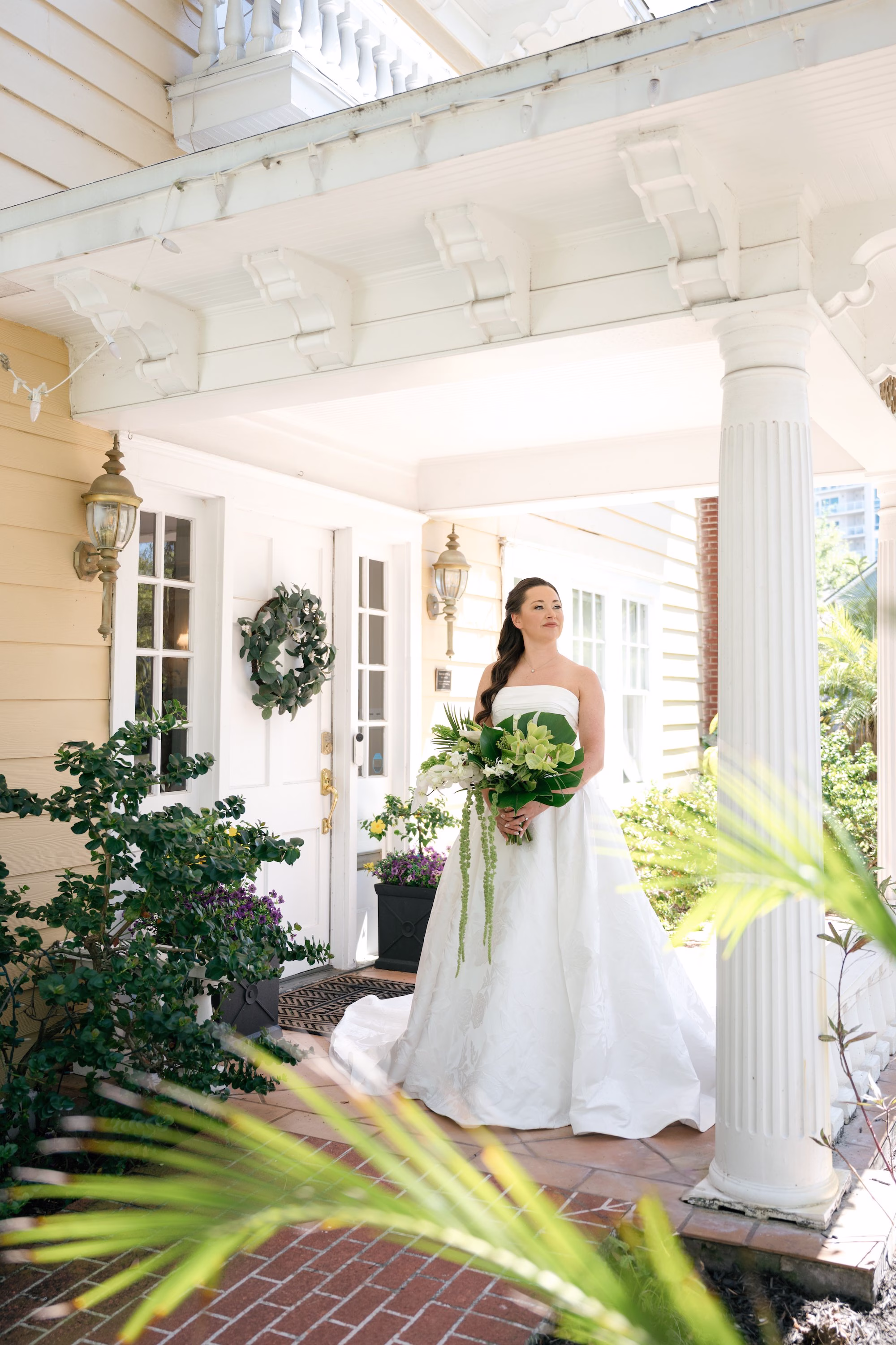 6Tropical Green Florida Wedding Ideas - Tropical, Green Downtown St. Pete Wedding | Poynter Institute Bride Wedding Portrait | White Orchid and Floral Wedding Bridal Bouquet with Large Tropical Palm Greenery Inspiration | Slicked Back Half Up Hair Down Curled Wedding Bridal Hair Ideas | Florida Hair and Makeup Adore Bridal | Tampa Bay Photographer Dewitt For Love