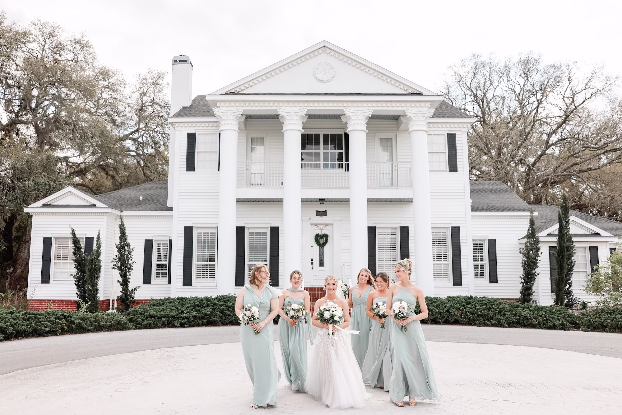 Bride and Bridesmaids Wedding Portrait | Sage Green Chiffon Bridesmaid Dress Inspiration | Classic White Roses Bouquet Ideas | Clearwater Photographer Lifelong Photography Studio | Tampa Bay Event Venue Legacy Lane Weddings