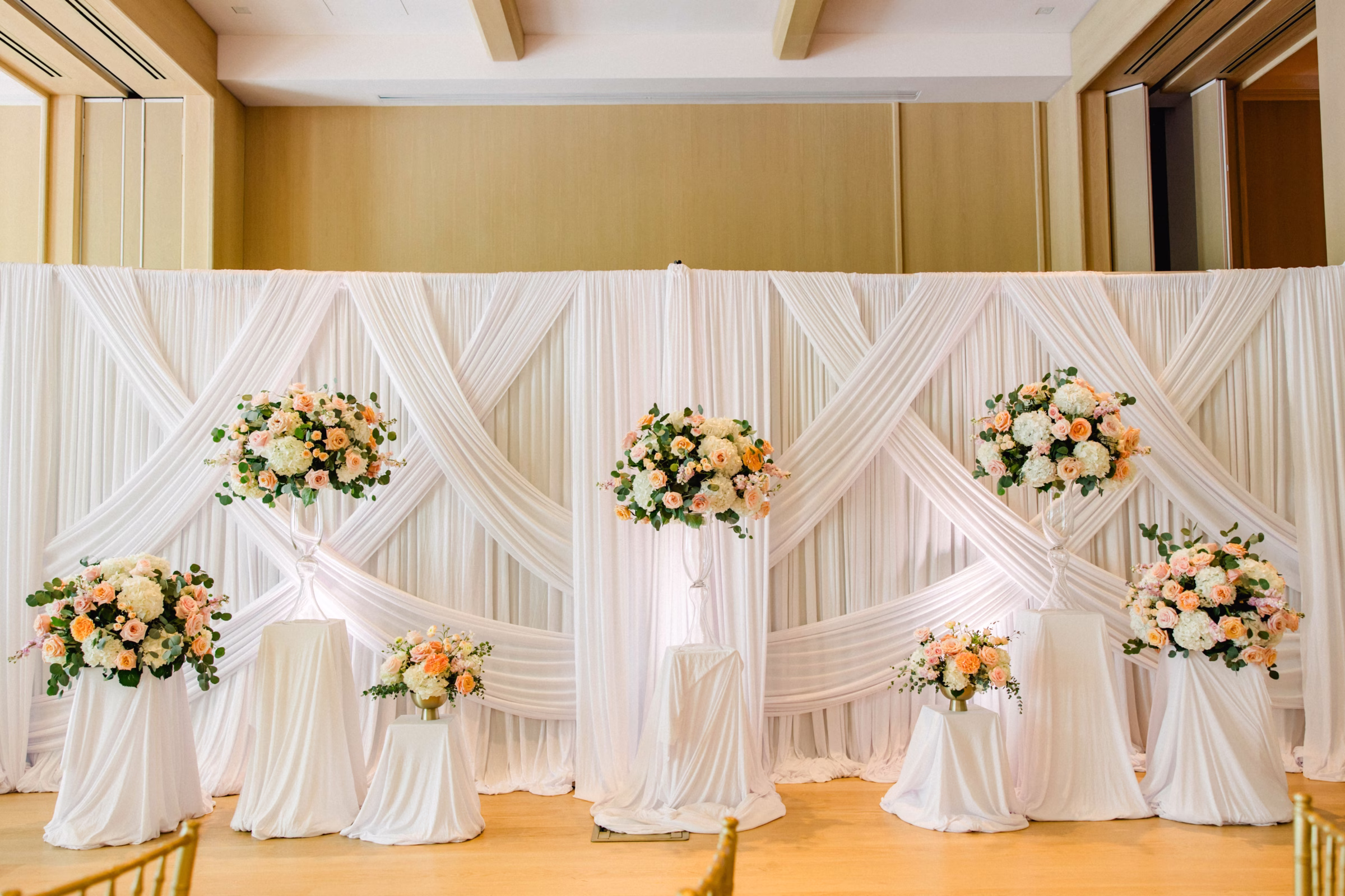 Spring Pastel Roses, Hydrangeas Blush, Peach, Cream, White Wedding Ceremony Floral Arrangement Decor Inspiration | White Draping Ceremony Decor Ideas