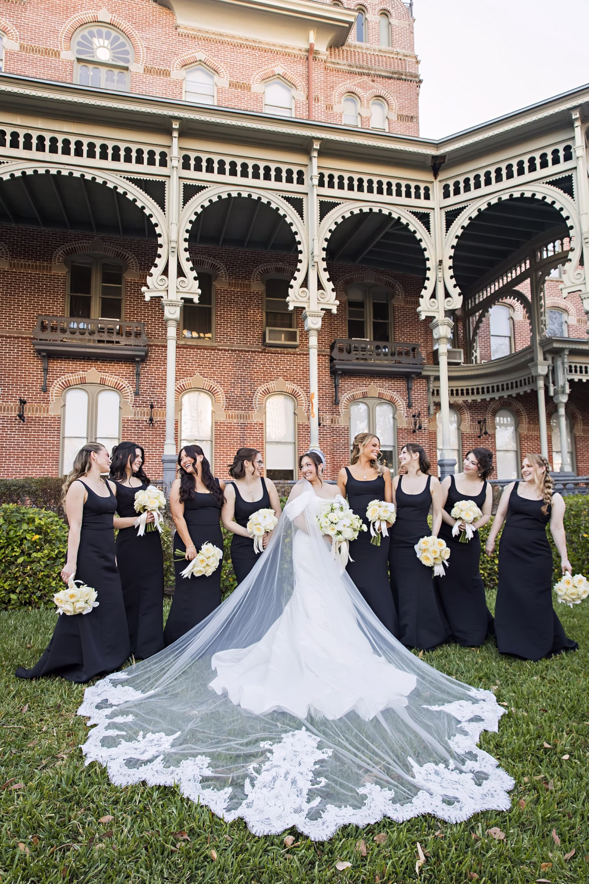 Bride and Bridesmaid Wedding Portrait at University of Tampa | Black Square Neck Bridesmaid Dresses Inspiration | Monochromatic White Bridal Bouquet Ideas | Traditional Cathedral Length Intricate Lace Trimmed Veil Inspiration | Tampa Bay Photographer Limelight Photography