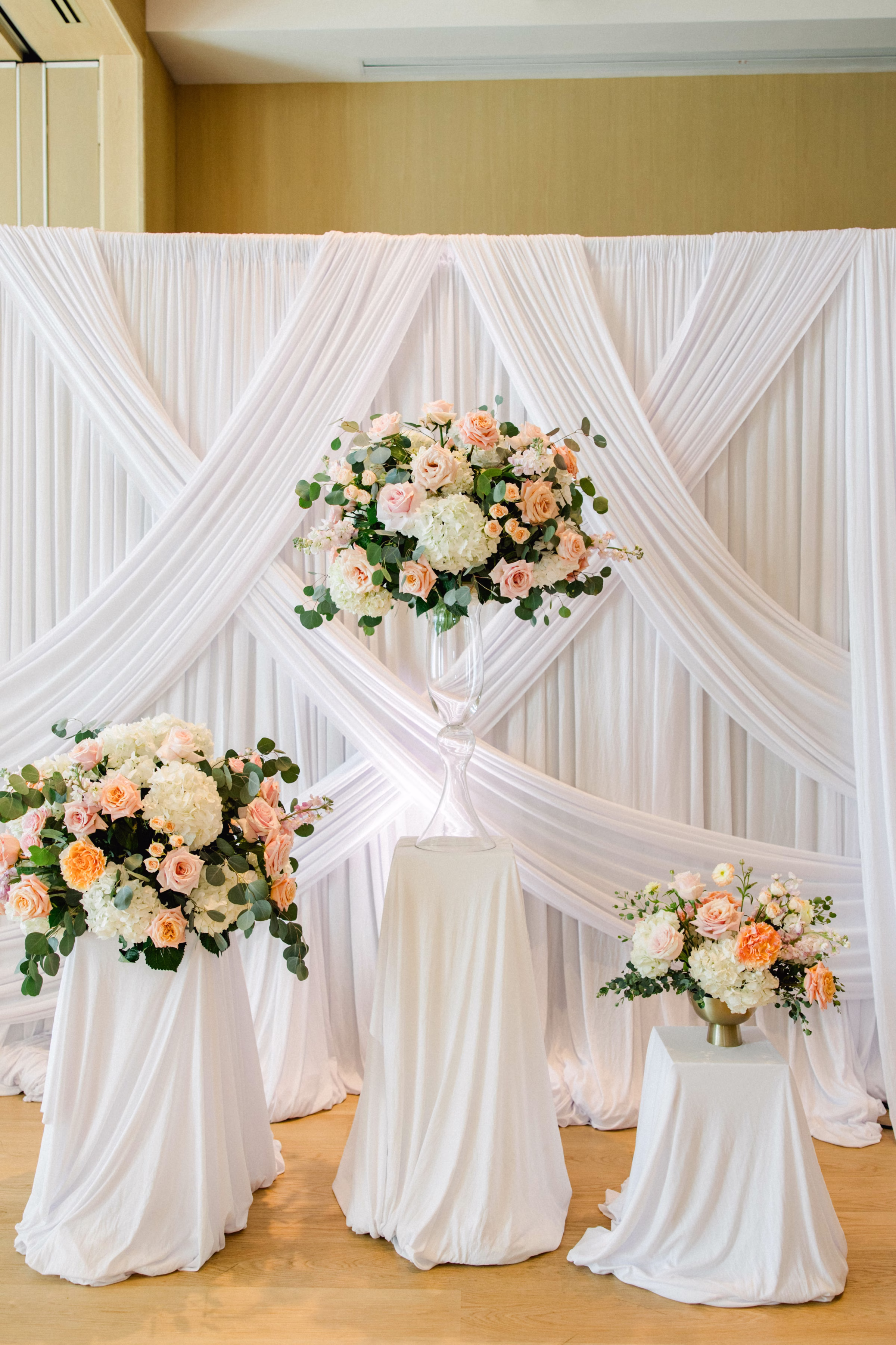 Spring Pastel Roses, Hydrangeas Blush, Peach, Cream, White Wedding Ceremony Floral Arrangement Decor Inspiration | White Draping Ceremony Decor Ideas